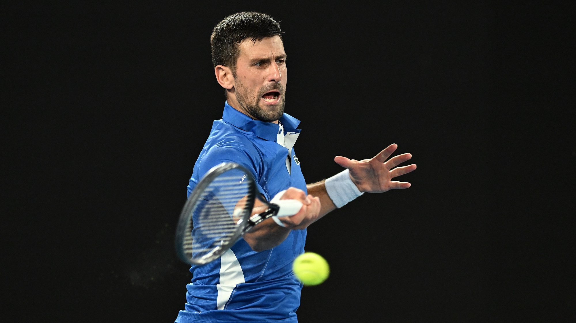 epa11075687 Novak Djokovic of Serbia returns during his first round match against Dino Prizmic of Croatia on Day 1 of the 2024 Australian Open at Melbourne Park in Melbourne, Australia, 14 January 2024.  EPA/LUKAS COCH AUSTRALIA AND NEW ZEALAND OUT