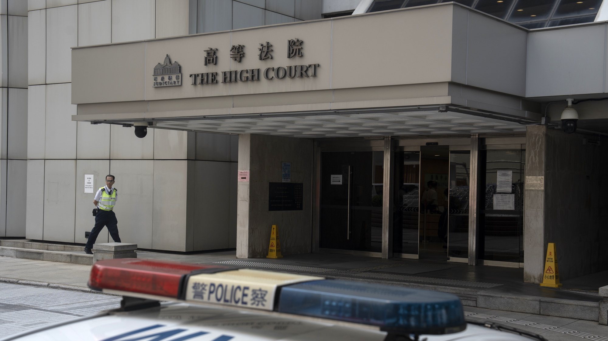 epa11326174 A private security officer walks outside of The High Court building in Hong Kong, China, 08 May 2024. The Court issued a ruling on 08 May to ban the song &#039;Glory to Hong Kong&#039;.  EPA/LEUNG MAN HEI