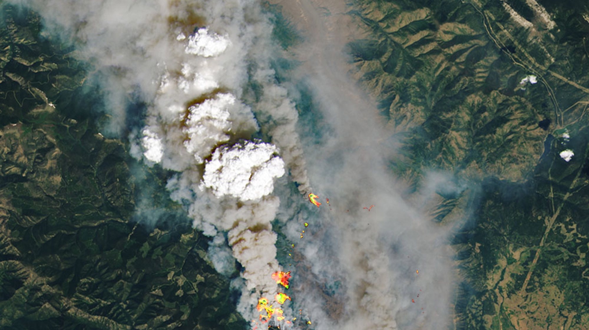epa09316834 A handout satellite image made available by the National Aeronautics and Space Administration (NASA) shows a detailed view of the McKay Creek fire, some 23km north of the community of Lillooet, British Columbia (BC), Canada, 30 June 2021 (issued 02 July 2021). This natural-color satellite image was overlaid at source with shortwave-infrared light to highlight the active fire. More than 40 wildfires were burning across the Canadian province by the end of June 2021, according to data released by the BC Wildfire Service. A heatwave has hit Canada and north-west USA sending temperatures to dangerous highs.  EPA/NASA HANDOUT  HANDOUT EDITORIAL USE ONLY/NO SALES