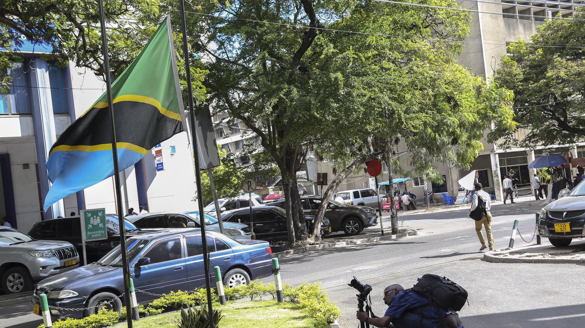 epa09081157 A journalist records the Tanzanian flag flying at half mast in Dar es Salaam, the largest city and commercial port in Tanzania, 18 March 2021. Tanzania&#039;s Vice president Samia Suluhu Hassan in a TV address announced that Tanzanian President John Magufuli has died on 17 March 2021 at the age of 61.  EPA/ANTHONY SIAME