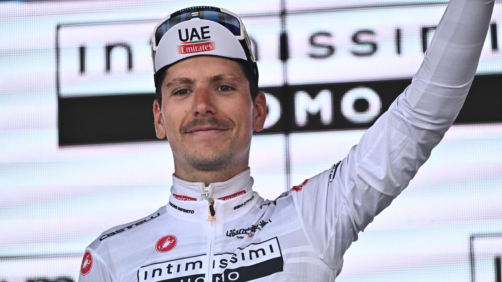 epa10653569 Portuguese rider Joao Almeida of UAE Emirates Team wearing the best young rider&#039;s white jersey celebrates on the podium after the 18th stage of the Giro d&#039;Italia 2023 cycling tour over 161 km from Oderzo to Val di Zoldo, Italy, 25 May 2023.  EPA/LUCA ZENNARO