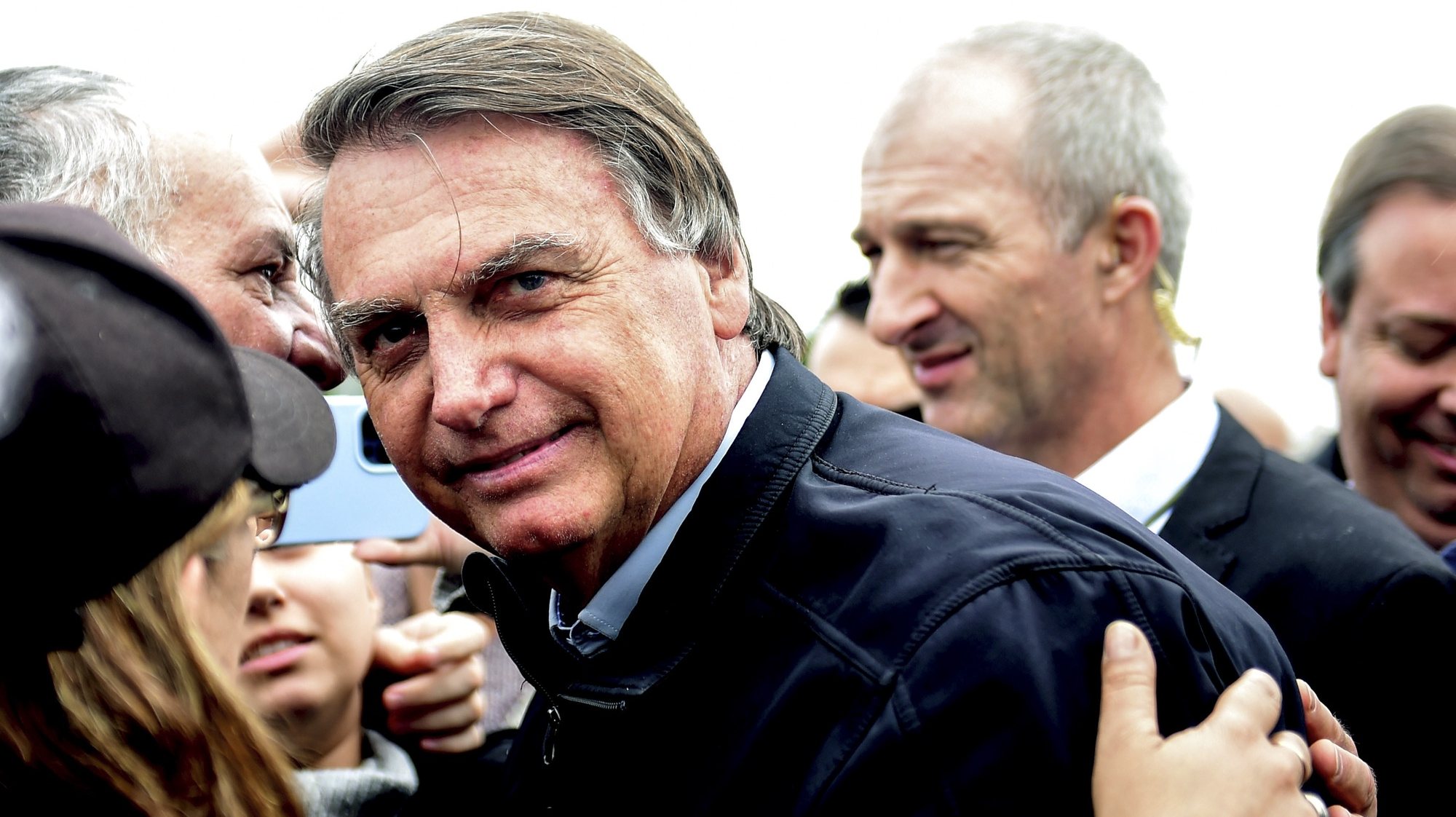 epa10706438 Former Brazilian President Jair Bolsonaro (C) is received by supporters in Porto Alegre, Rio Grande do Sul, Brazil, 22 June 2023. The Superior Electoral Court of Brazil opened on 22 June in Brasilia the first hearing of a trial in which it will analyze the alleged abuses committed by former President Jair Bolsonaro during the campaign for the 2022 October elections. The far-right leader is accused of abusing his position as head of state to promote his candidacy and maintain a harsh discredit campaign against the electoral Justice itself and democratic institutions.  EPA/RICARDO RIMOLI