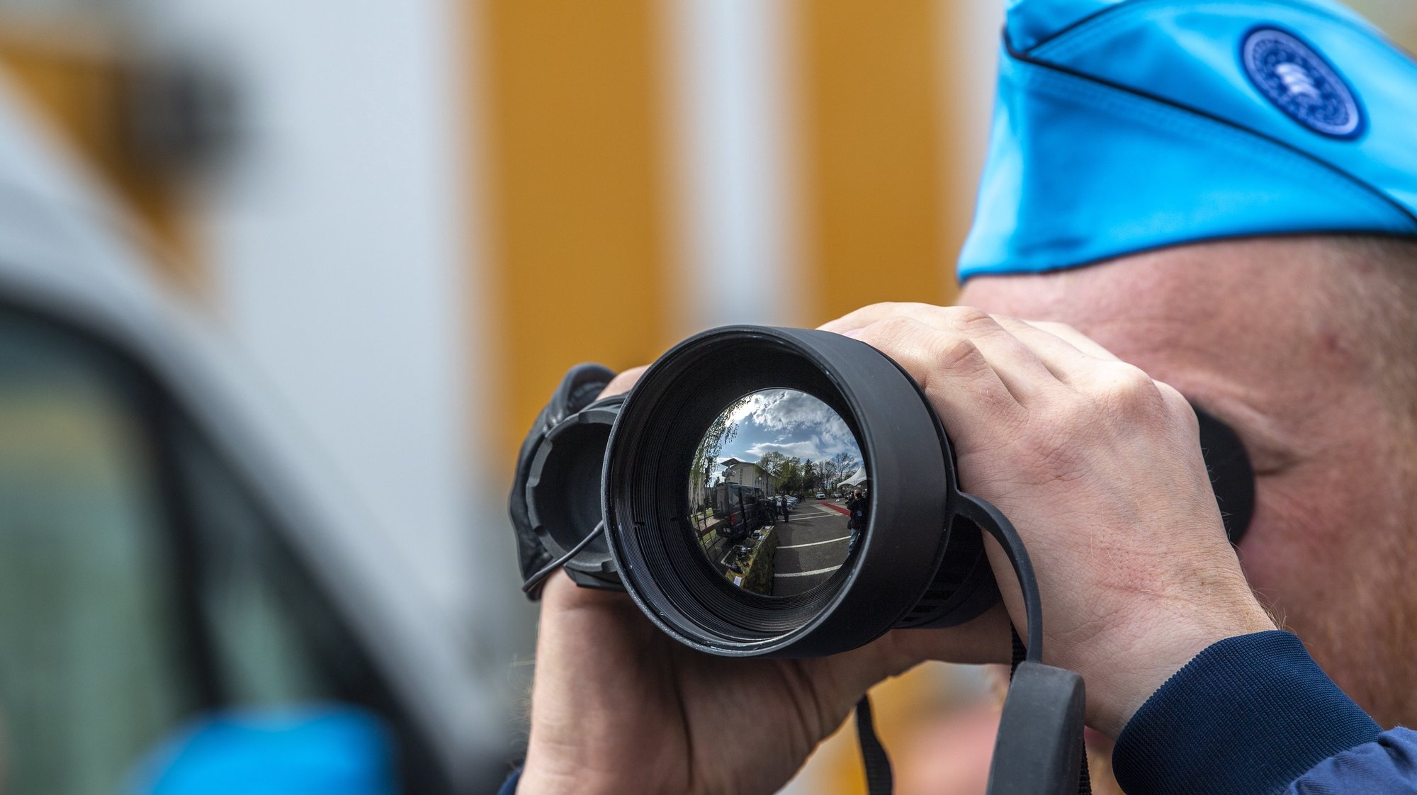 epa10581578 A member of FRONTEX looks through the monocular prior to the official launch ceremony of the FRONTEX Joint Operation in Skopje, Republic of North Macedonia, 20 April 2023. It is planned that in 2023, FRONTEX will deploy more than 100 officers, patrol vehicles and special equipment on the Macedonian-Greek border, which will significantly increase the capacity to detect illegal activities along the border, while respecting and protecting the basic rights of every person.  EPA/GEORGI LICOVSKI