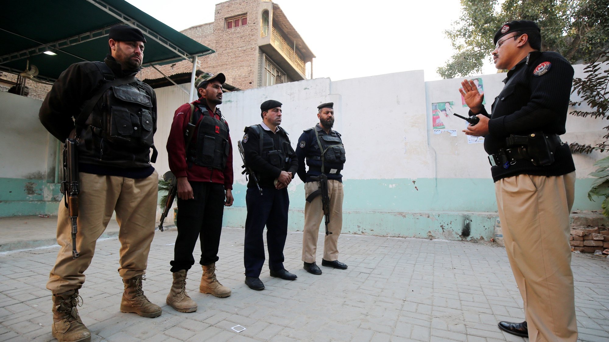 epa11135690 Pakistani security officials stand guard outside the polling station during general elections in Peshawar, Pakistan, 08 February 2024. Pakistani voters headed to heavily guarded polling stations on 08 February, to elect a new government for a five-year term amid increased security threats. According to the election body, the polling started at 8 a.m. local time and will continue until 5 p.m. The counting of millions of votes cast will start soon after polling time is over. There are more than 128 million registered voters, 59.3 million (46 percent) women and 69.2 million or 54 percent men. More than 20 million new voters have been registered for the 2024 elections. There are nearly 18,000 candidates out of whom 5,112 including 4797 males, 313 women, and two transgender contestants, running for 266 contestable parliamentary seats.  EPA/ARSHAD ARBAB