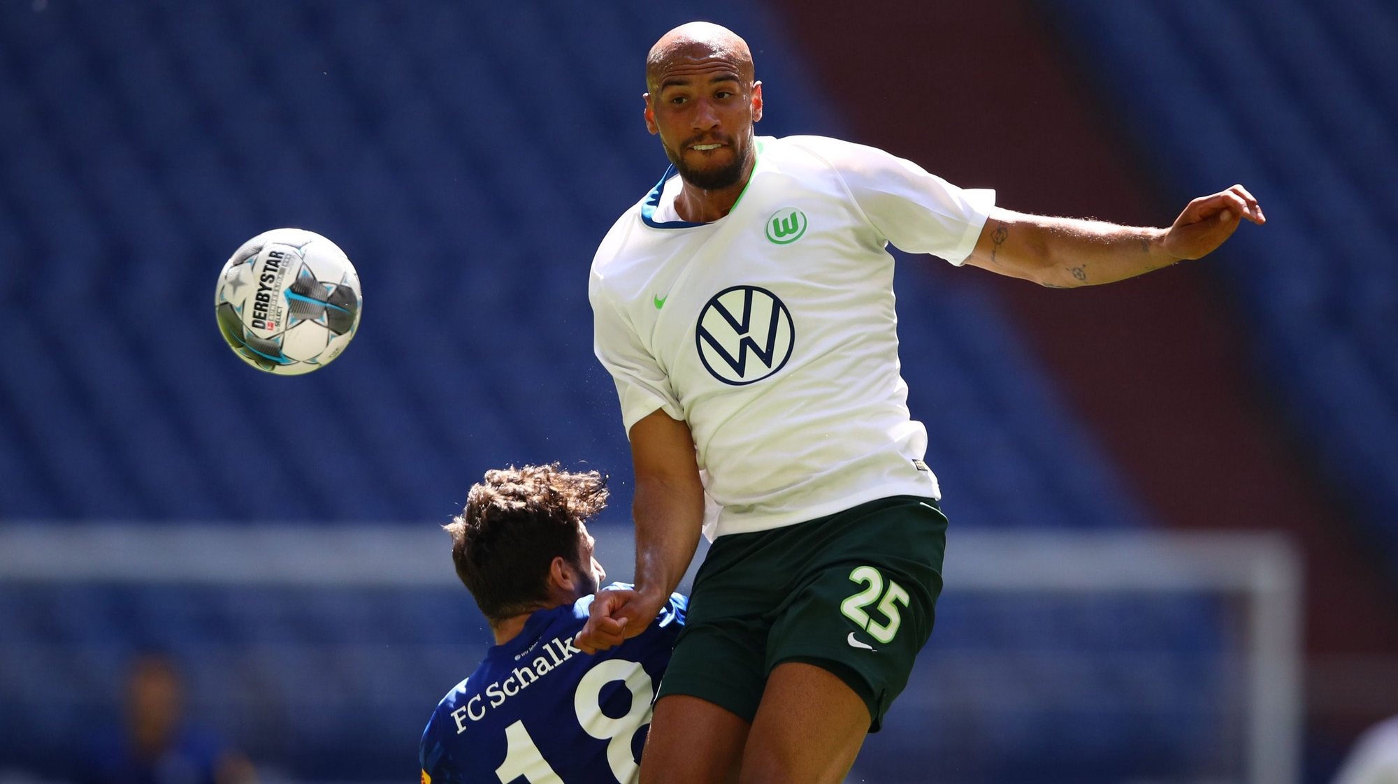 epa08497867 John Brooks (R) of VfL Wolfsburg heads the ball over Daniel Caligiuri of Schalke 04 during the German Bundesliga soccer match between FC Schalke 04 and VfL Wolfsburg at Veltins-Arena in Gelsenkirchen, Germany, 20 June 2020.  EPA/Dean Mouhtaropoulos / POOL DFL regulations prohibit any use of photographs as image sequences and/or quasi-video.