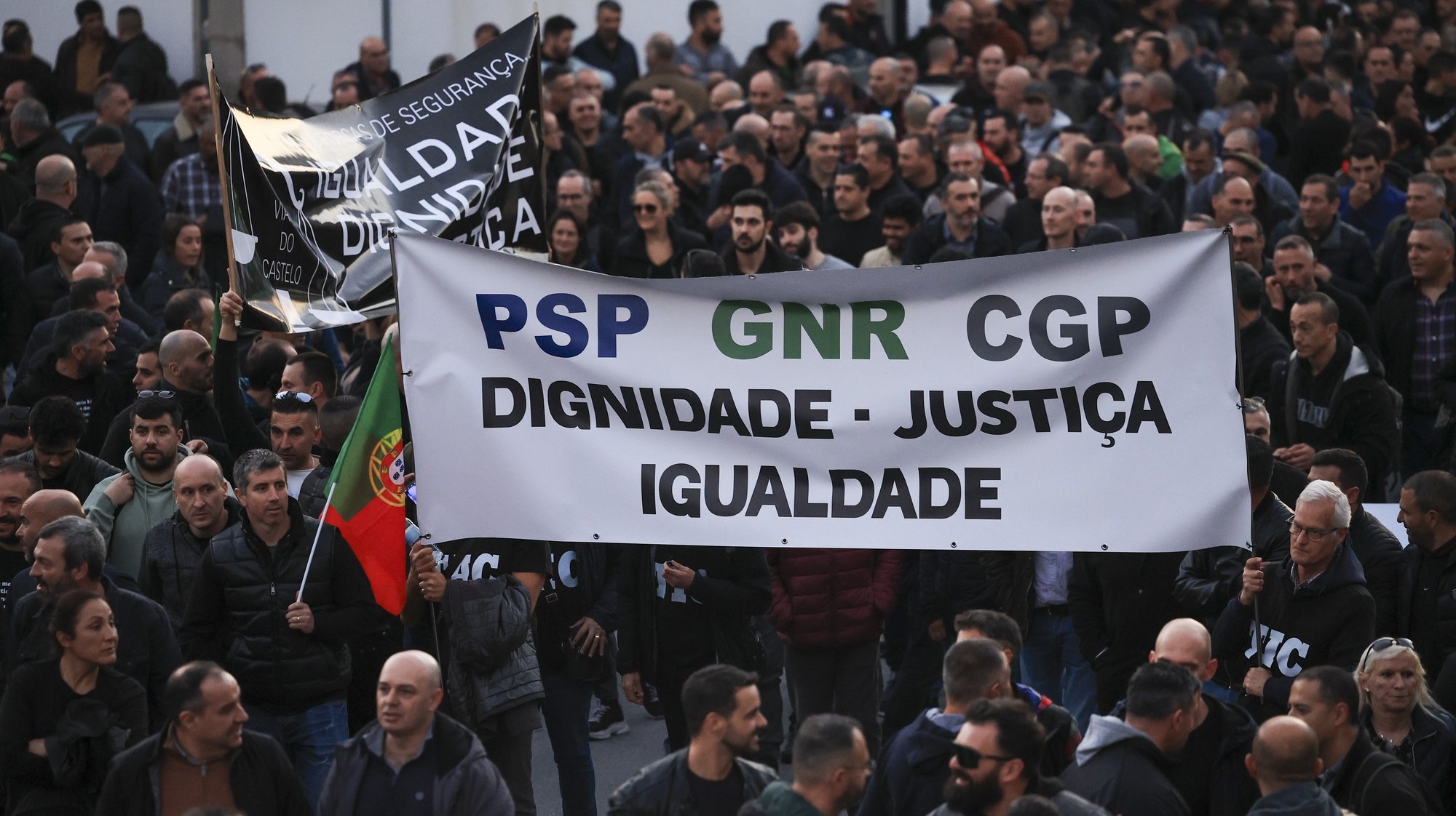Police officers hold a banner with the words &quot;Dignity, Justice, Equality&quot; protest during a demonstration by the platform of PSP (Public Security Police) unions and GNR (National Republican Guard) associations for the restructuring of pay supplements and for the enhancement and dignification of professionals, Porto, Portugal, 31 January 2024.  ESTELA SILVA/LUSA