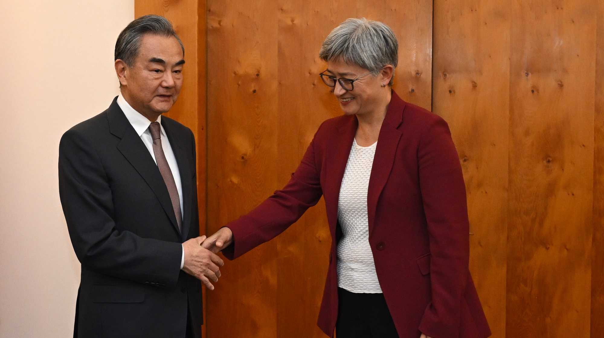 epa11230473 Australian Foreign Minister Penny Wong (R) shakes hands with Chinese Foreign Minister Wang Yi (L) during a meeting at Parliament House, in Canberra, Australia, 20 March 2024.  EPA/LUKAS COCH AUSTRALIA AND NEW ZEALAND OUT