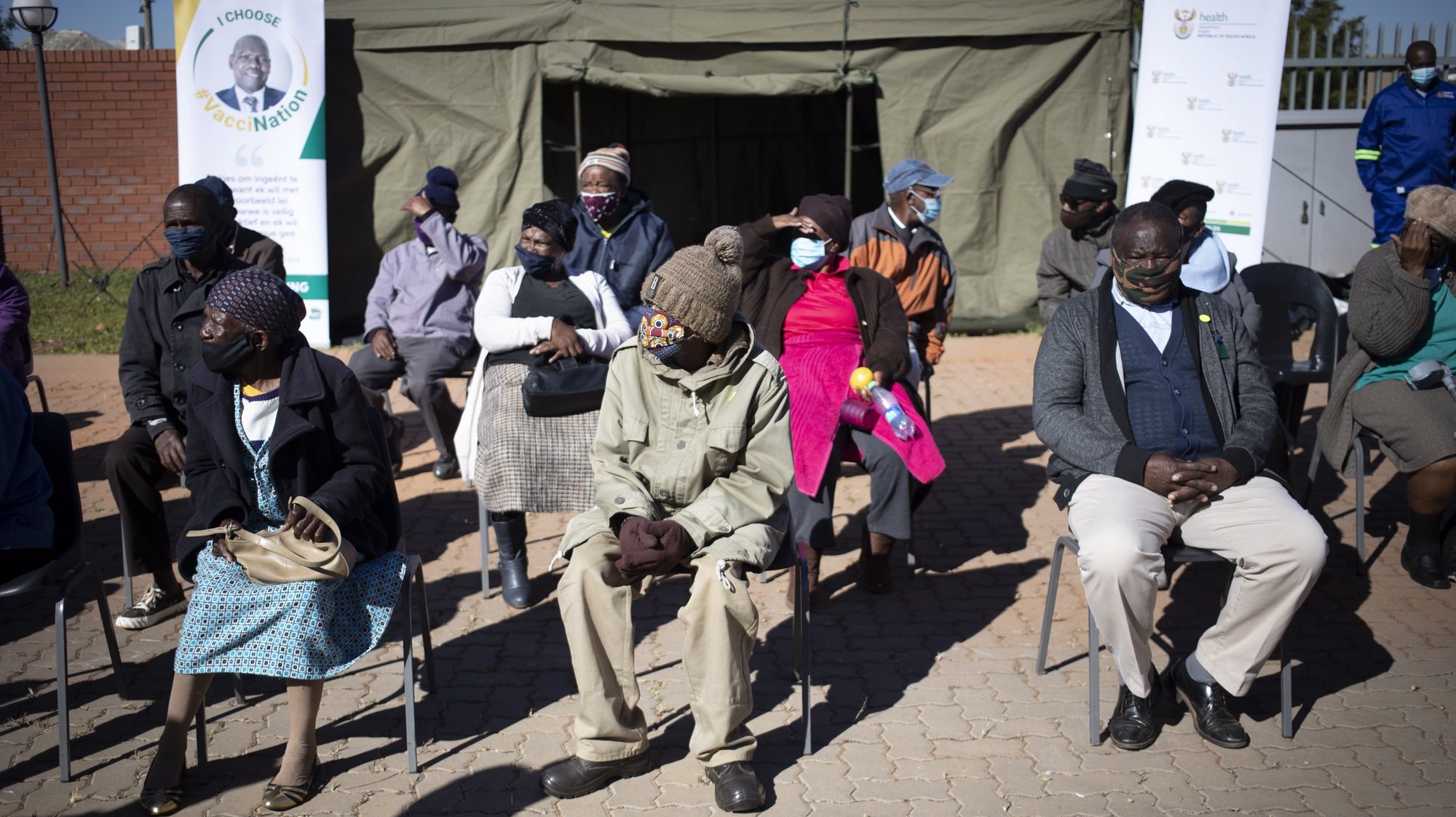 epa09206341 Elderly members of the community wait in line to receive their vaccination during the first day of Covid-19 vaccinations for the over 60 year old population in the country, in Johannesburg, South Africa, 17 May 2021. The first round of vaccinations was for the health care workers in the country. South Africa is lagging behind many countries in the world in its vaccination program.  EPA/Kim Ludbrook