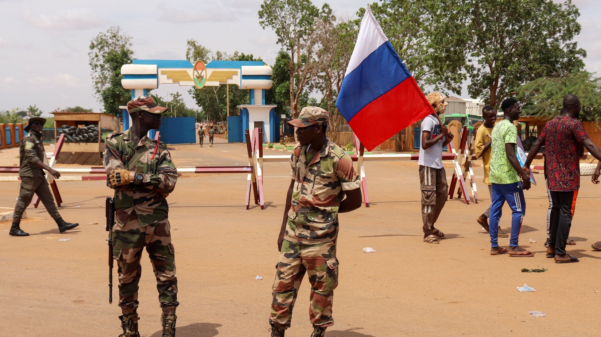 epa10824342 Supporters of the military junta carry a Russian flag as they gather at a roundabout leading to the French airbase during a rally in Niamey, Niger, 27 August 2023. The junta gave the French ambassador to Niger 48 hours to leave the country.  EPA/ISSIFOU DJIBO