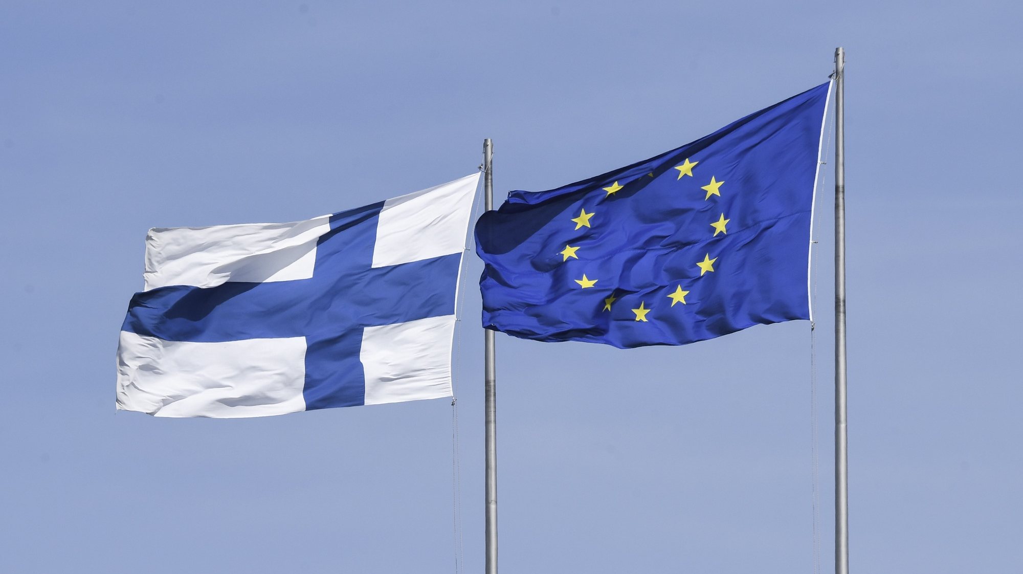epa07557935 Finland&#039;s national flag (L) and the EU flag (R) seen during the Europe Day celebrations in Finnish capital Helsinki, Finland, 09 May 2019. The Europe Day event was co-organized by the Finnish Foreign Ministry, Finnish Broadcasting Corporation YLE, European Movement Finland, Young European Federalists Europe, and European Commission as well as the  European Parliament. The Europe Day has been celebrated 09 May since 1985 and comes ahead of the European Parliament elections, to be held between 23 and 26 May 2019.  EPA/KIMMO BRANDT