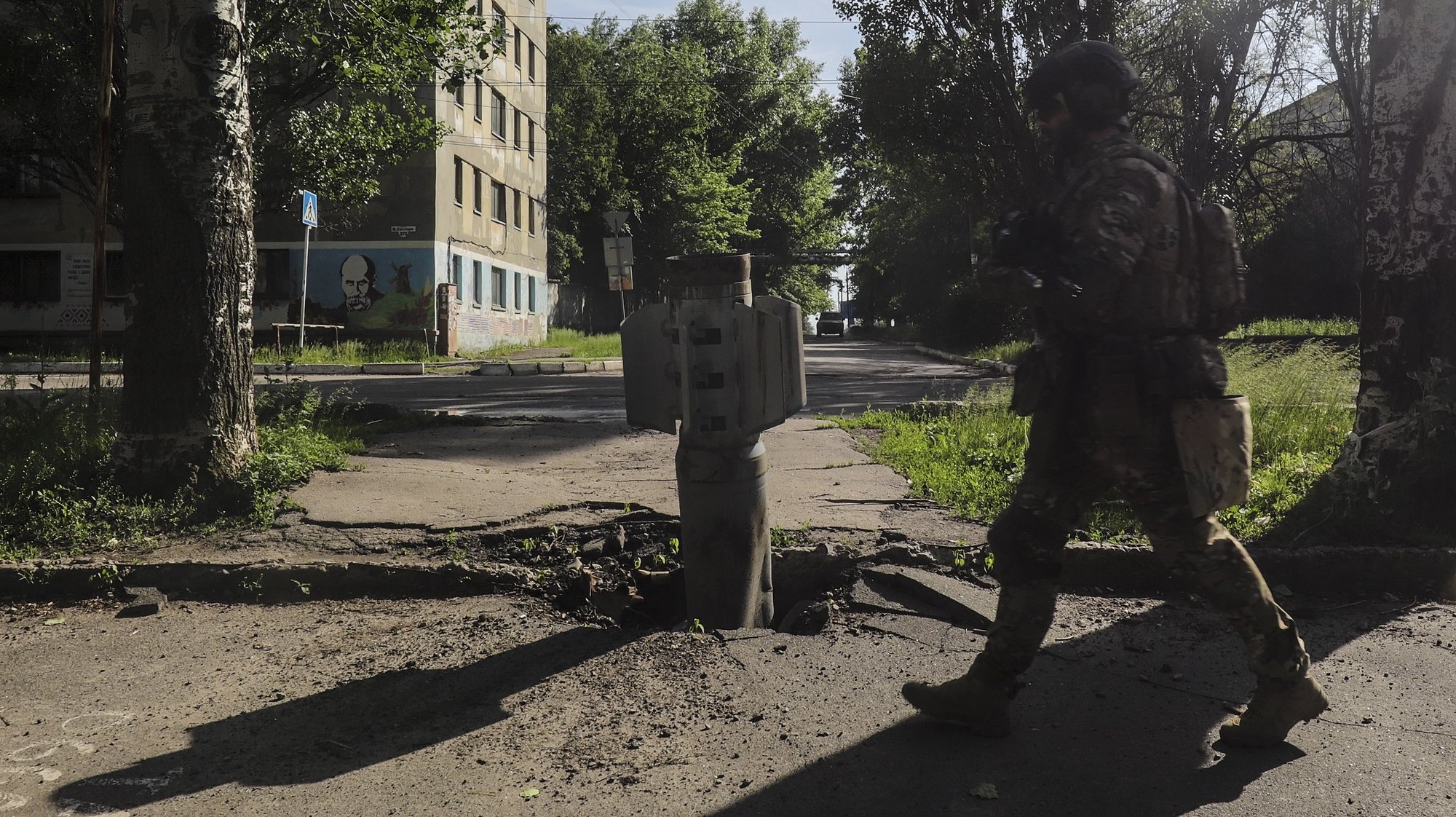 epa09992798 A Ukrainian soldier walks past a part of a rocket near the front line in the city of Severodonetsk, Luhansk region, Ukraine, 02 June 2022, where heavy fighting took place in the last few days. While addressing the Luxembourg parliament, Ukrainian President Volodymyr Zelensky said that as of 02 June, about 20 percent of Ukraine is under the control of Russia. Russian troops on 24 February entered Ukrainian territory, starting a conflict that has provoked destruction and a humanitarian crisis.  EPA/STR