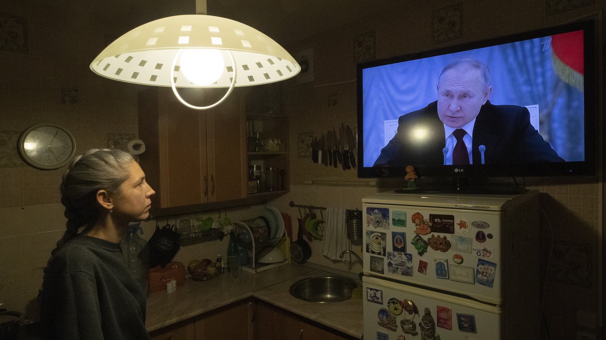 epa09840174 (FILE) - A woman watches TV with Russian President Putin speaking during a broadcast of a meeting of the National Security Council on the recognition of the self-proclaimed Donetsk People&#039;s Republic (DPR) and the Luhansk People&#039;s Republic (LPR), in St. Petersburg, Russia, 21 February 2022 (issued 21 March 2022). Putin said he was considering a request from leaders of the two self-proclaimed republics to recognise them as independent states, less than a week after the Duma on 15 February voted to appeal to President Putin to recognise the two Donbas regions. The regions declared independence in 2014 amid an armed conflict in the eastern Ukraine.  EPA/Anatoly Maltsev  ATTENTION: This Image is part of a PHOTO SET *** Local Caption *** 57496979