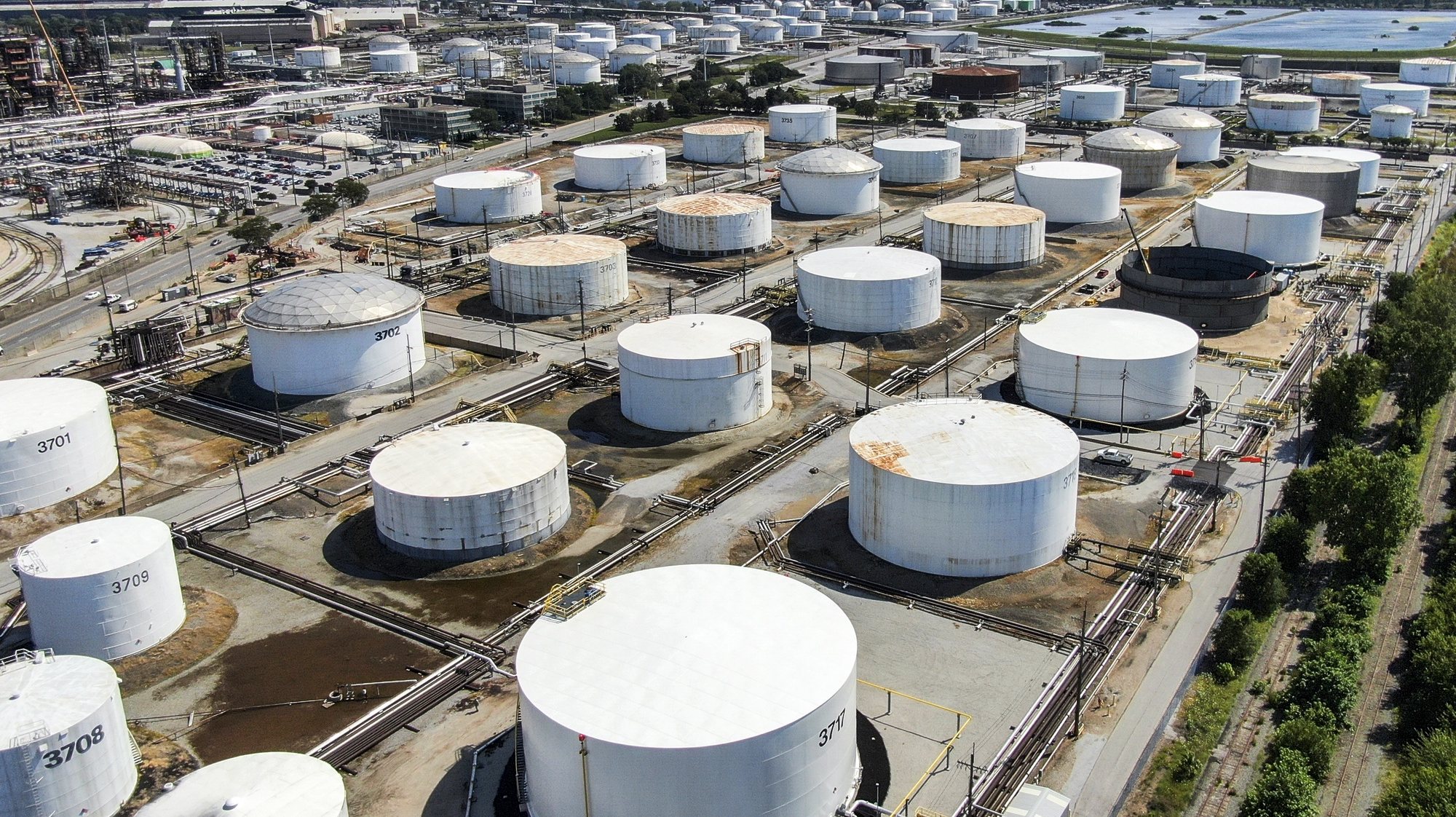 epa07803127 An aerial view taken with a drone shows oil storage tanks at the BP oil refinery in Whiting, Indiana, USA, 29 August 2019. The facility has the capability of handling 400,000 barrels of crude oil per day and it is the sixth largest oil refinery in the USA. Standard Oil of Indiana first established the refinery in 1889.  EPA/TANNEN MAURY