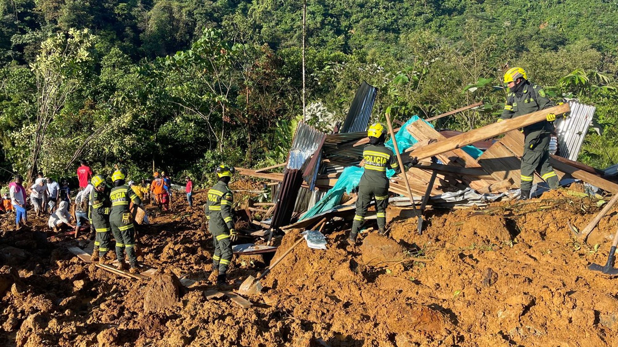 epa11074106 A handout photo made available by the National Police shows rescue workers in the area where a landslide occurred on a road near the town Carmen de Atrato, Choco department, Colombia, 12 January 2024 (issued 13 January 2024). At least 23 people died and 25 others were injured on 12 January in two landslides on a road near the town of Carmen de Atrato, in the western Colombian department of Choco, mayor of Carmen de Atrato, Jaime Herrera, confirmed. The landslide occurred on the road between Medellin and Quibdo, the capital of Choco, apparently caused by a flood, and buried several vehicles.  EPA/NATIONAL POLICE HANDOUT EDITORIAL USE ONLY/NO SALES HANDOUT EDITORIAL USE ONLY/NO SALES HANDOUT EDITORIAL USE ONLY/NO SALES