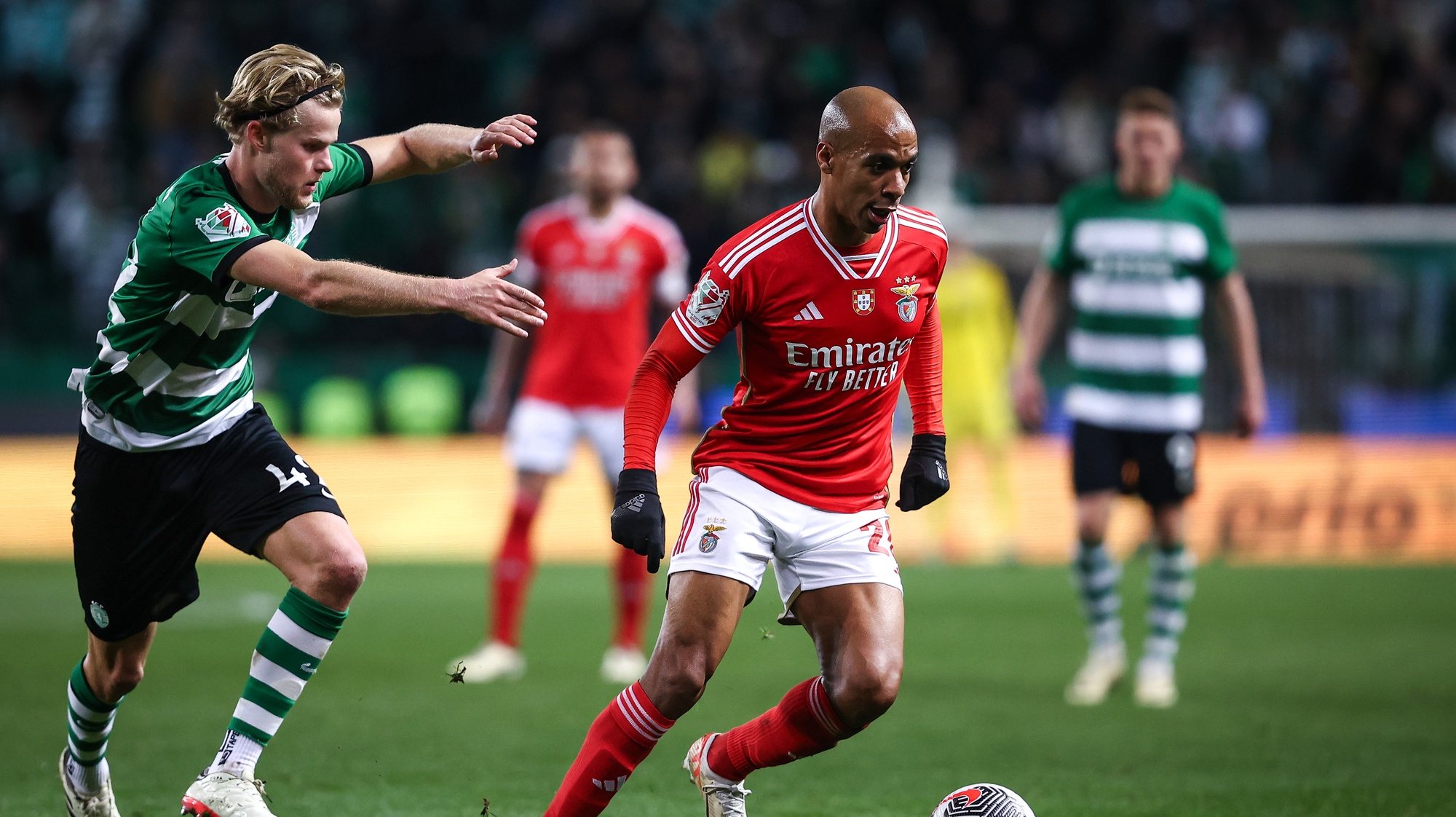 Sporting CP player Morton Hjulmand (L) in action against Benfica player João Mário (C) during the Portugal Soccer Cup first leg semi-final match held at Alvalade Stadium, in Lisbon, Portugal, 29 February 2024. RODRIGO ANTUNES/LUSA
