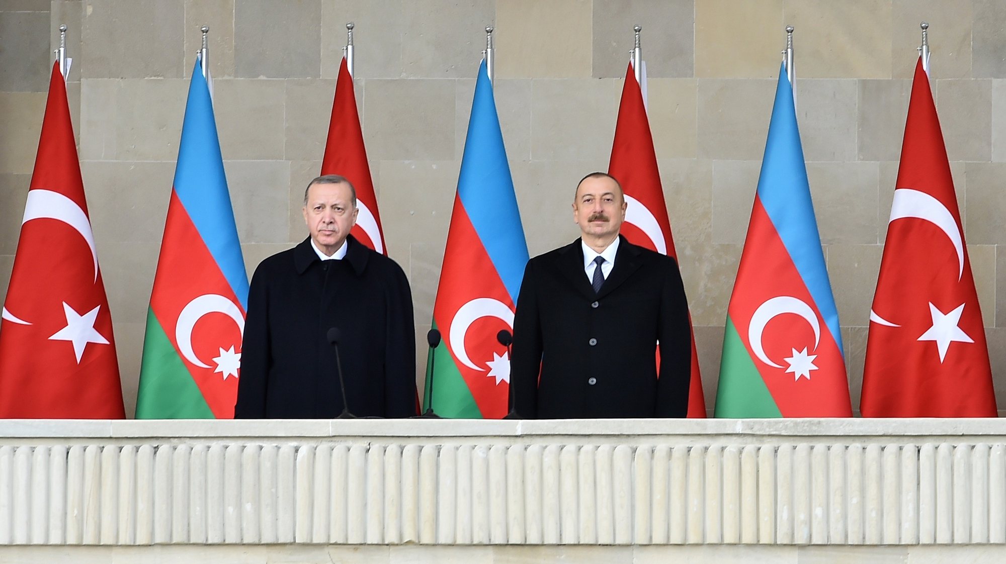 epa08874748 Azerbaijani President Ilham Aliyev (R) and Turkish President Recep Tayyip Erdogan (L) attend a military parade dedicated to the victory in the Nagorno-Karabakh armed conflict, in Baku, Azerbaijan, 10 December 2020. The simmering territorial conflict between Azerbaijan and Armenia over Nagorno-Karabakh territory erupted into a war between the two countries on 27 September 2020 along the contact line of the self-proclaimed Nagorno-Karabakh Republic (also known as Artsakh). On 09 November 2020 Presidents of Azerbaijan and Russia and Armenian Prime Minister signed a joint statement announcing a complete ceasefire and halt of all military operations in the Nagorno-Karabakh conflict zone, and return of the Aghdam, Kalbajar and Lachin districts to Azerbaijan.  EPA/POMAN ISMAYILOV