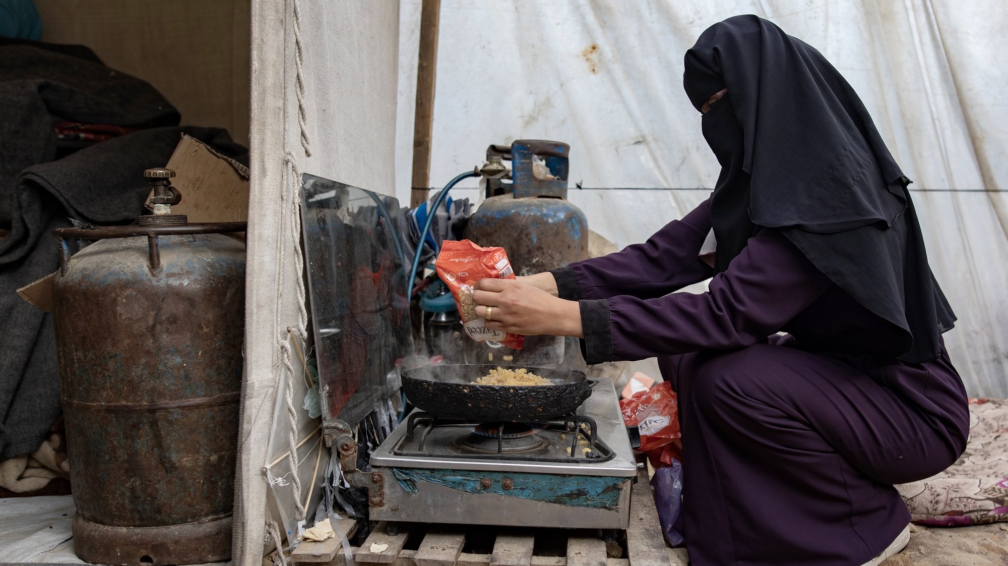 epa11235176 Internally displaced Palestinian Hanan Al-Shafi&#039;i &#039;Umm Adl&#039;, 30, a mother to nine children, cooks on a stove, at their shelter in Khan Yunis, southern Gaza Strip, 21 March 2024. Hanan said that she and her children have been displaced twice within Khan Yunis since the outbreak of the conflict. With no access to fresh water, her children walk long distances to fetch water to meet their daily needs of 40 liters of clean water for drinking and cooking and 70 liters for washing and personal hygiene. According to the United Nations, the majority of people in the Gaza Strip face dire water and sanitation conditions as WASH (water, sanitation, hygiene) facilities that provide basic services have been damaged or destroyed. Since 07 October 2023, up to 1.9 million people have been displaced throughout the Gaza Strip, according to UNRWA, which added that most civilians in Gaza are in &#039;desperate need of humanitarian assistance and protection&#039;. World Water Day, which is held annually on 22 March, focuses on the importance of global access to safe and clean water. This year&#039;s theme is &#039;Leveraging Water for Peace&#039;.  EPA/HAITHAM IMAD