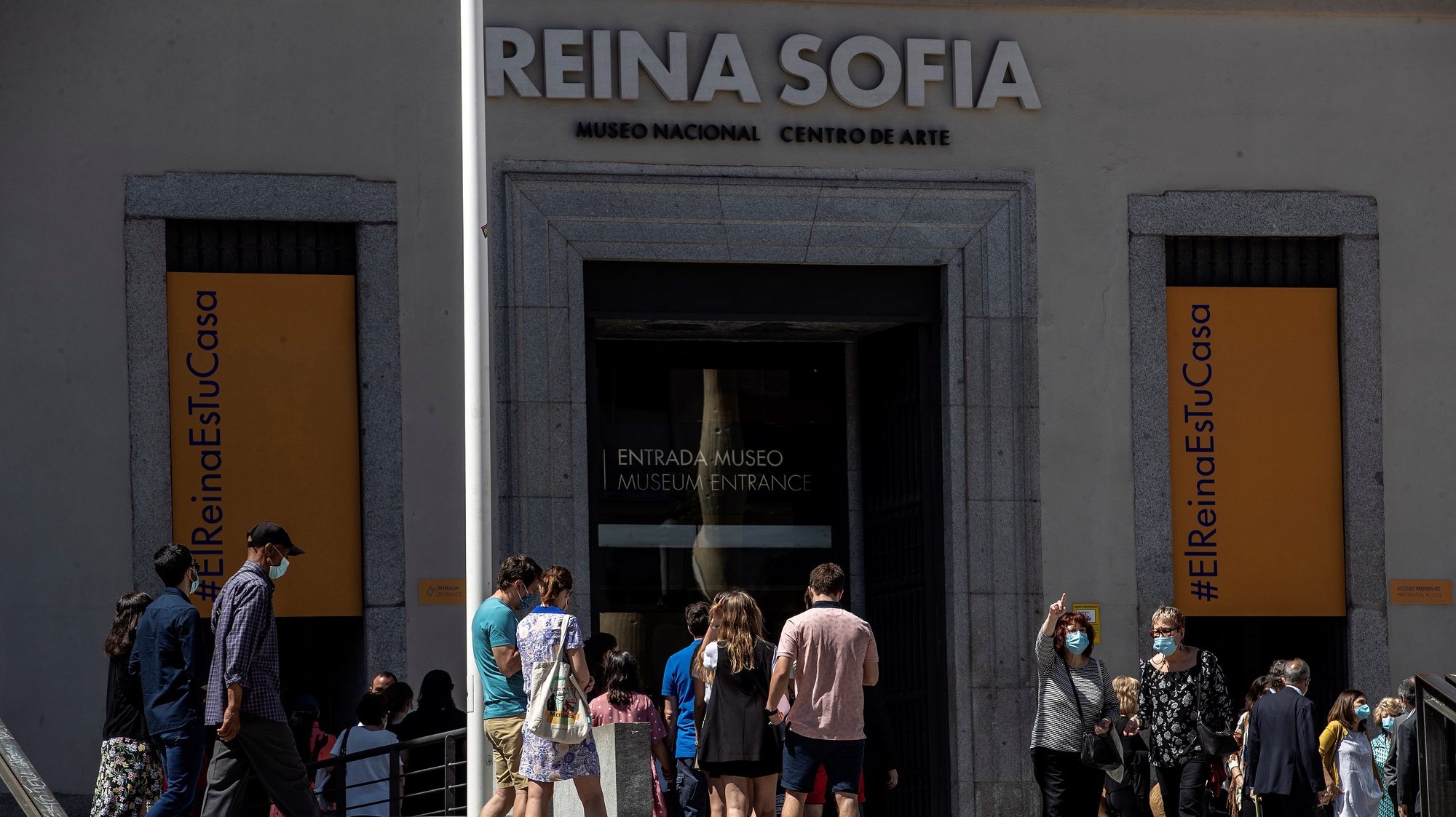 epa08468629 Visitors queue at the entrance to the Reina Sofia Museum on its reopening day in Madrid, Spain, 06 June 2020. El Prado, Thyssen-Bornemisza and Reina Sofia Museums are reopening 06 June 2020 in the Spanish capital with new security measures implanted because of the coronavirus health crisis.  EPA/CHEMA MOYA