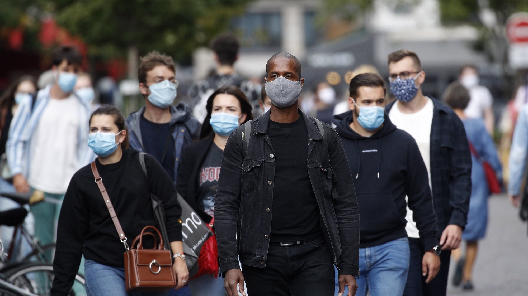 epa08632225 People wearing protective face masks walk in the streets in Paris, France, 28 August 2020. As of 8am on 28 August, protective face masks are mandatory across the city of Paris, a measure annouced by French Prime Minister Jean Castex on 27 August to fight the rising spread of coronavirus SARS-CoV-2 which causes the Covid-19 disease. Cases in France have surged in recent weeks, with over 6000 new cases recorded in a 24 hour period.  EPA/YOAN VALAT
