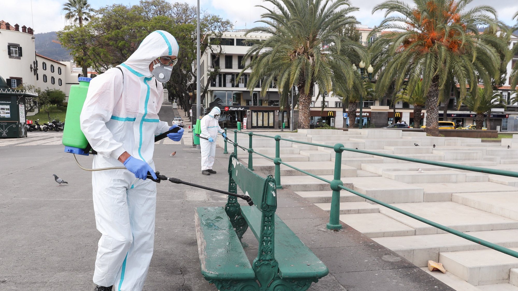 epa08312091 Municipal employees disinfect a street in the centre of Funchal due to the epidemic of covid-19, Madeira Island, Portugal, 21 March 2020. In Portugal, there are 12 deaths and 1,280 confirmed infections. Portugal is in a state of emergency from 00:00 on March 19th until 23:59 on 02 April. Countries around the world are taking increased measures to stem the widespread of the SARS-CoV-2 coronavirus which causes the Covid-19 disease.  EPA/HOMEM DE GOUVEIA