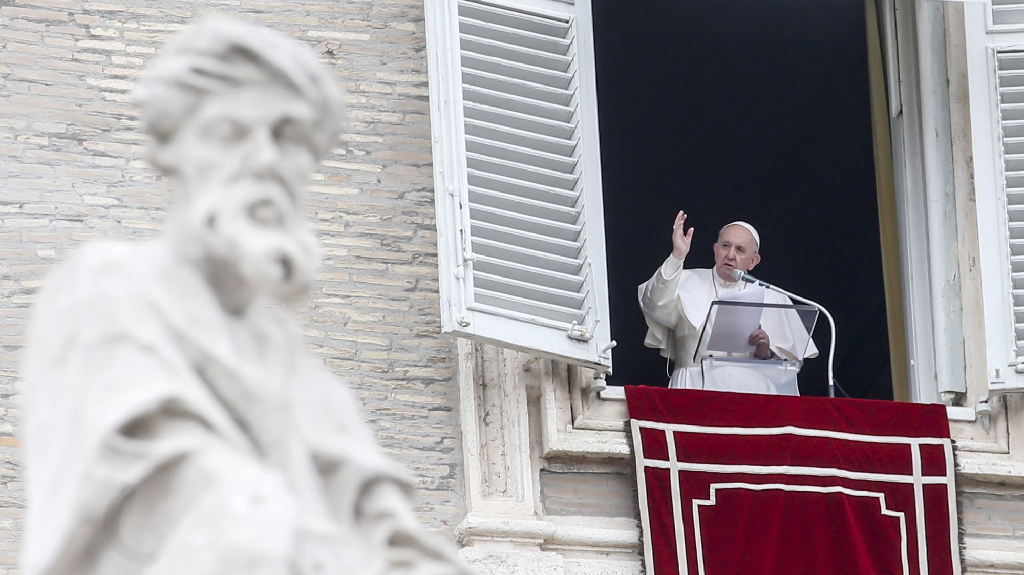 epa09073482 Pope Francis reciting the prayer of the Angelus from the window of his study overlooking Saint Peter&#039;s Square, Vatican City, 14 March 2021.  EPA/FABIO FRUSTACI