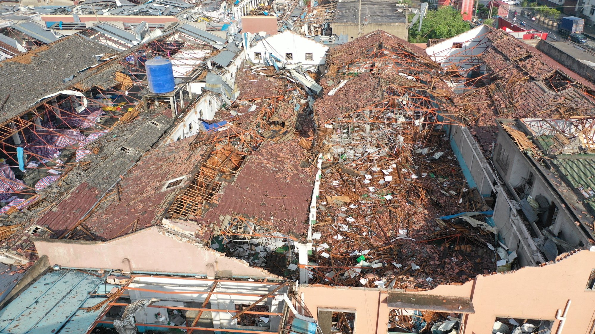 epa09200730 Aerial view of the aftermath of a tornado in Shengze township, Suzhou, Jiangsu province, China, 15 May 2021. At least one person was killed and over 20 were injured. Another tornado hit in Wuhan, killing six people and injuring over 200.  EPA/FANG DONGXU