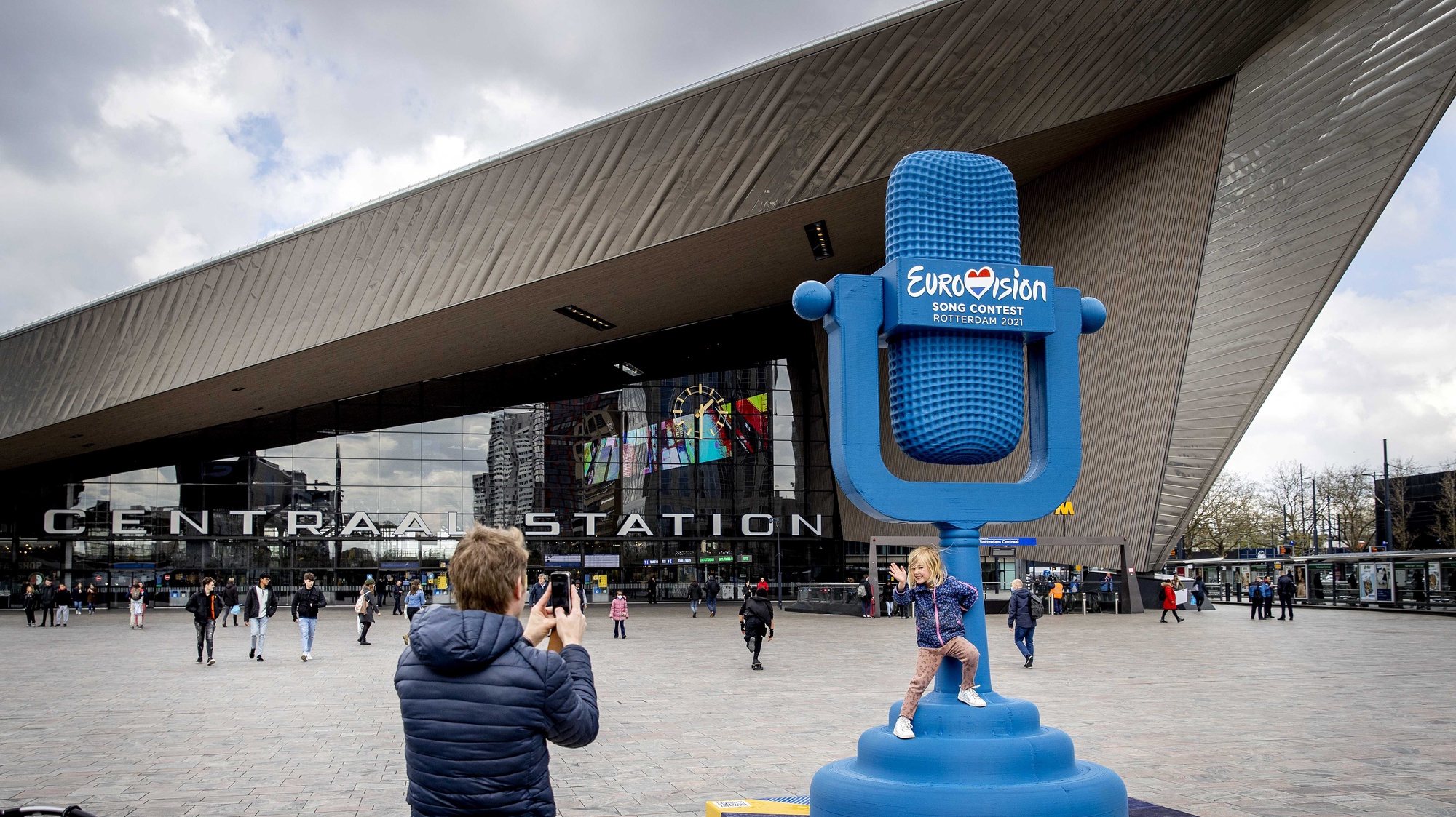 epa09183839 People take pictures next to a four-meter high, 3D-printed Eurovision trophy in front of Central Station made from recycled PET material from the Rotterdam waters, in Rotterdam, the Netherlands, 07 May 2021. The trophy will be auctioned after the Eurovision Song Contest. The 65th edition of the Eurovision Song Contest (ESC) will take place at the Rotterdam Ahoy and consist of two semi-finals, to be held on 18 and 20 May 2021, and a grand final on 22 May 2021.  EPA/SEM VAN DER WEL