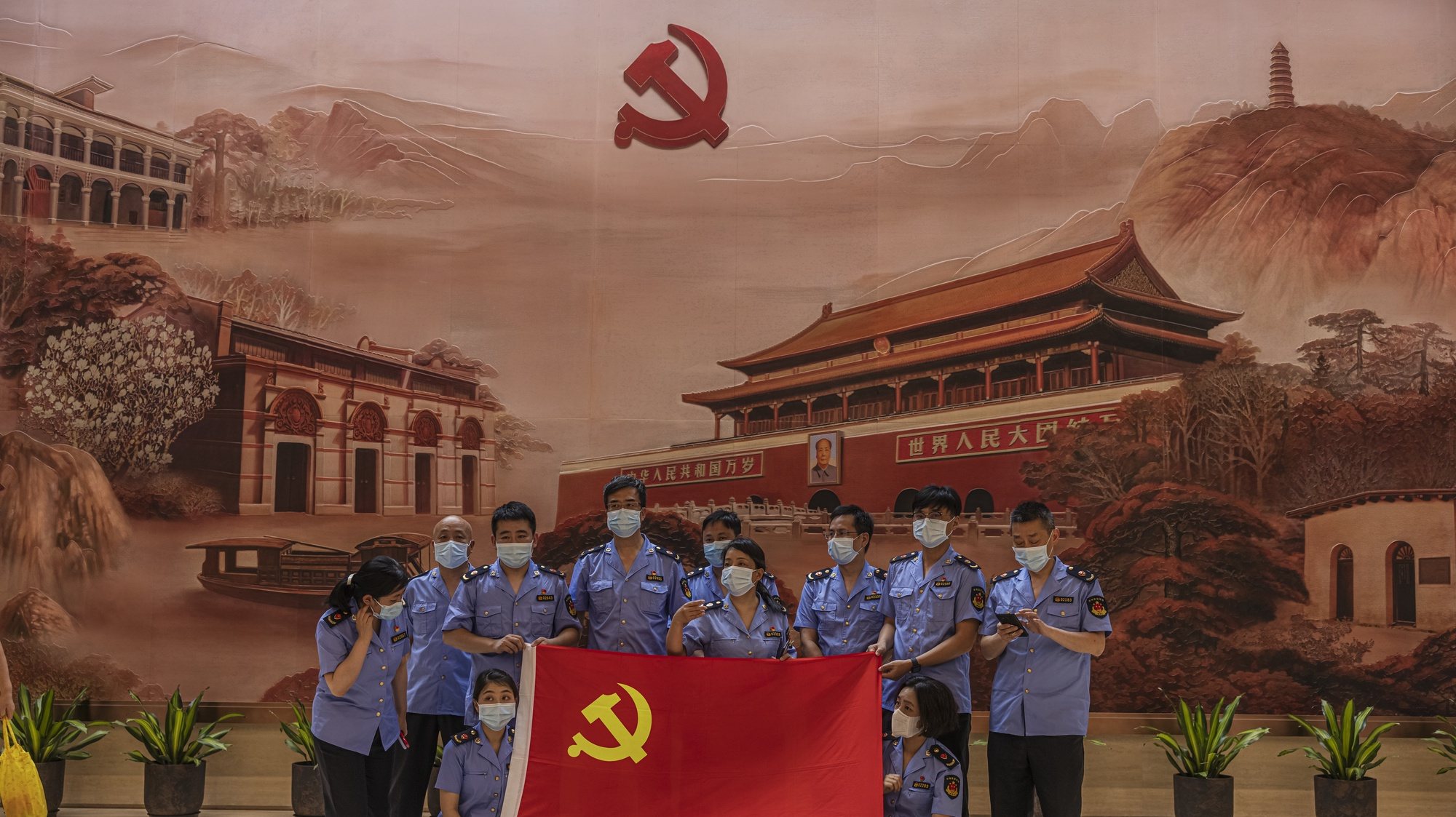 epa09314821 Members of the police pose in the Memorial of the 1st National Congress of the CPC (Chinese Communist Party), in Shanghai, China, 01 July 2021. China celebrates on 01 July the 100th anniversary of the founding of the ruling Chinese Communist Party.  EPA/ALEX PLAVEVSKI