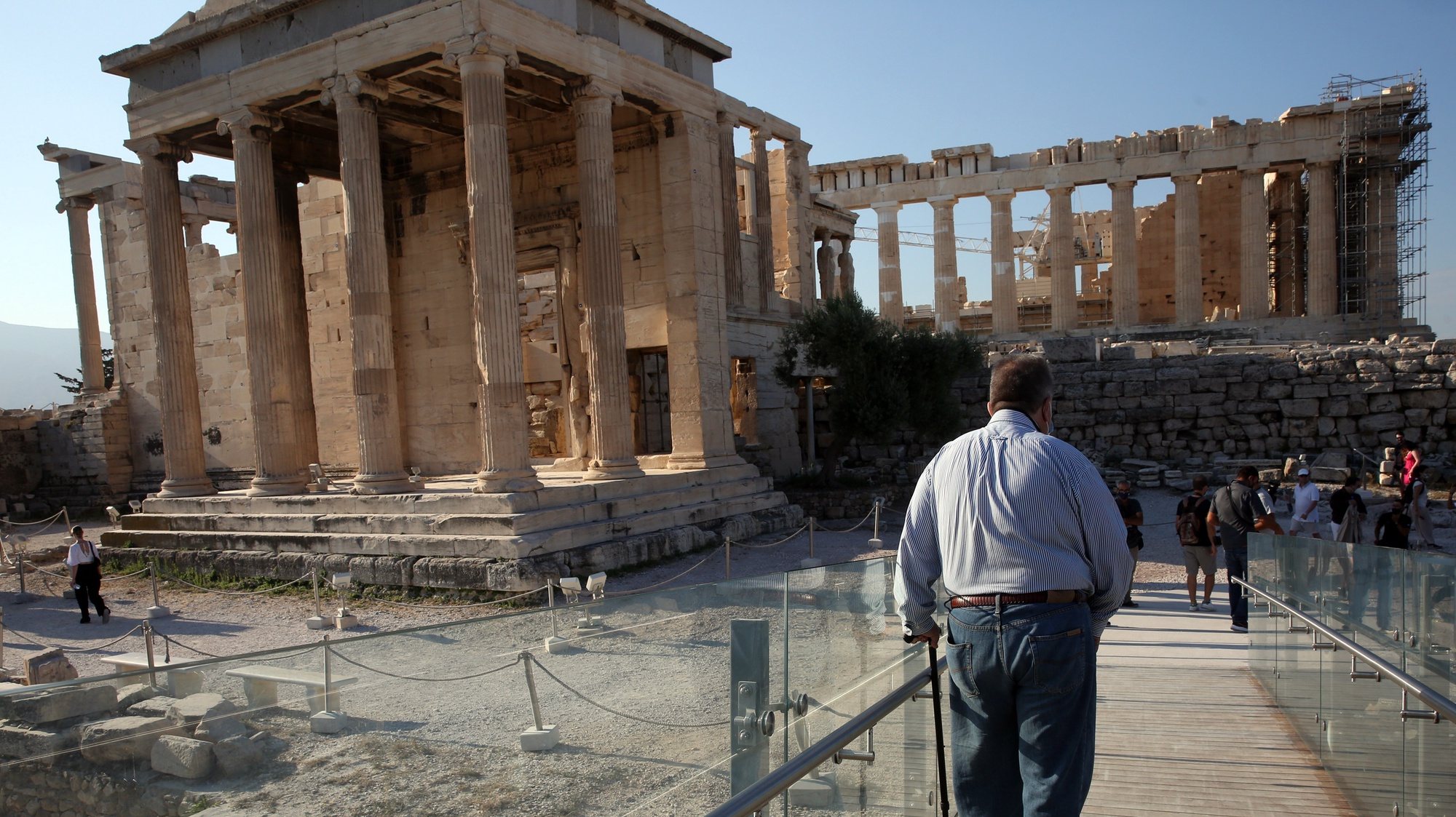 epa09354417 A man with mobility problems just used the elevator to visit the archaeological site of the Acropolis hill in Athens, Greece, 20 July 2021. People with similar problems have the opportunity to visit Acropolis due to the recent improvement works for the access of visitors with mobility issues, special needs and the elderly.  EPA/ORESTIS PANAGIOTOU