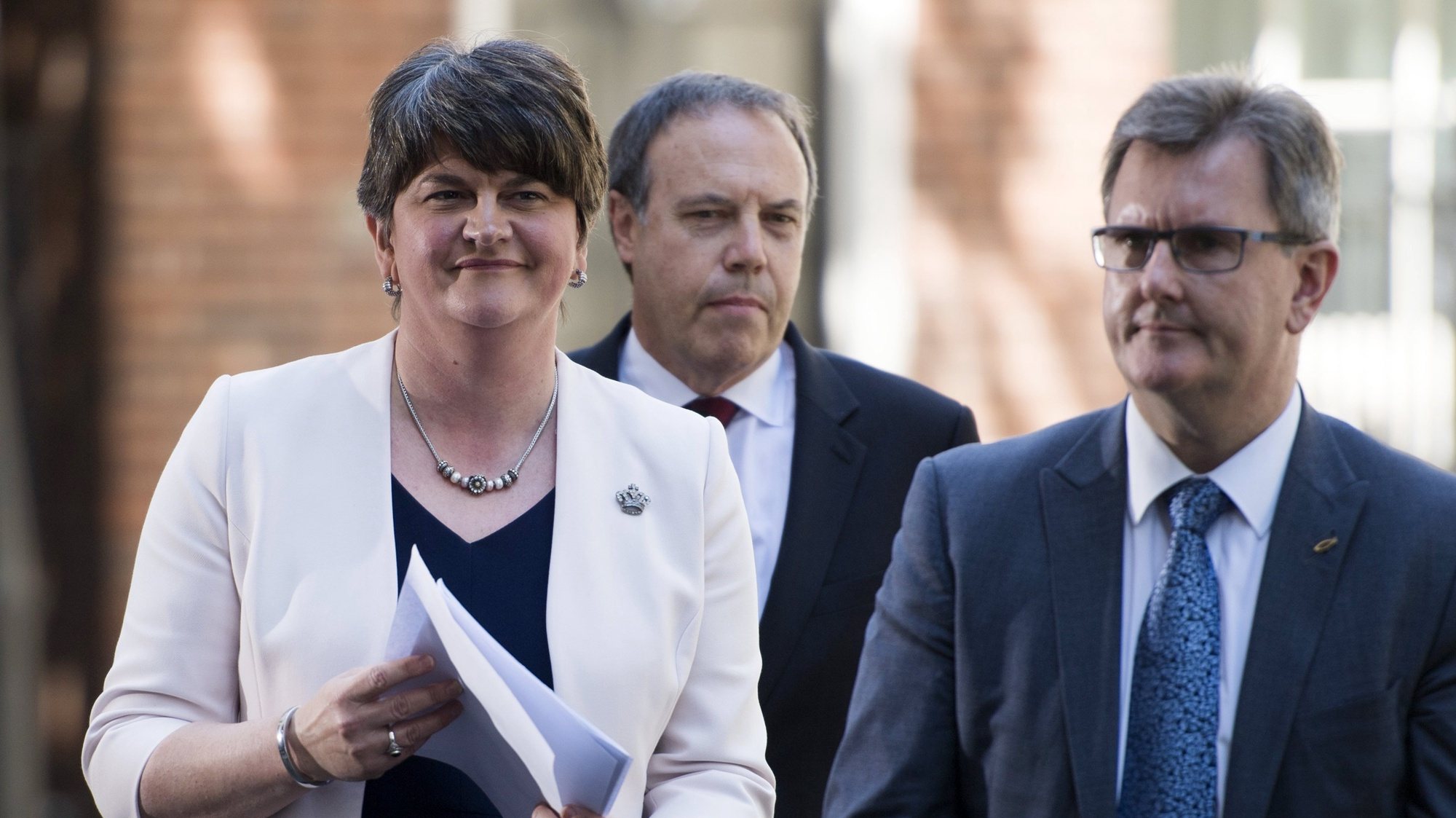 epa06051164 Leader of the Northern Ireland Democratic Unionist Party (DUP) Arlene Foster (L) Deputy Leader Nigel Dodds (C) and Chief Whip Jeffrey Donaldson (R) prepare to address members of the media outside 10 Downing Street, central London, Britain 26 June 2017. It has been announced that the DUP and Conservative party lead by Prime Minister Theresa May have agreed terms for an agreement to form a government.  EPA/WILL OLIVER