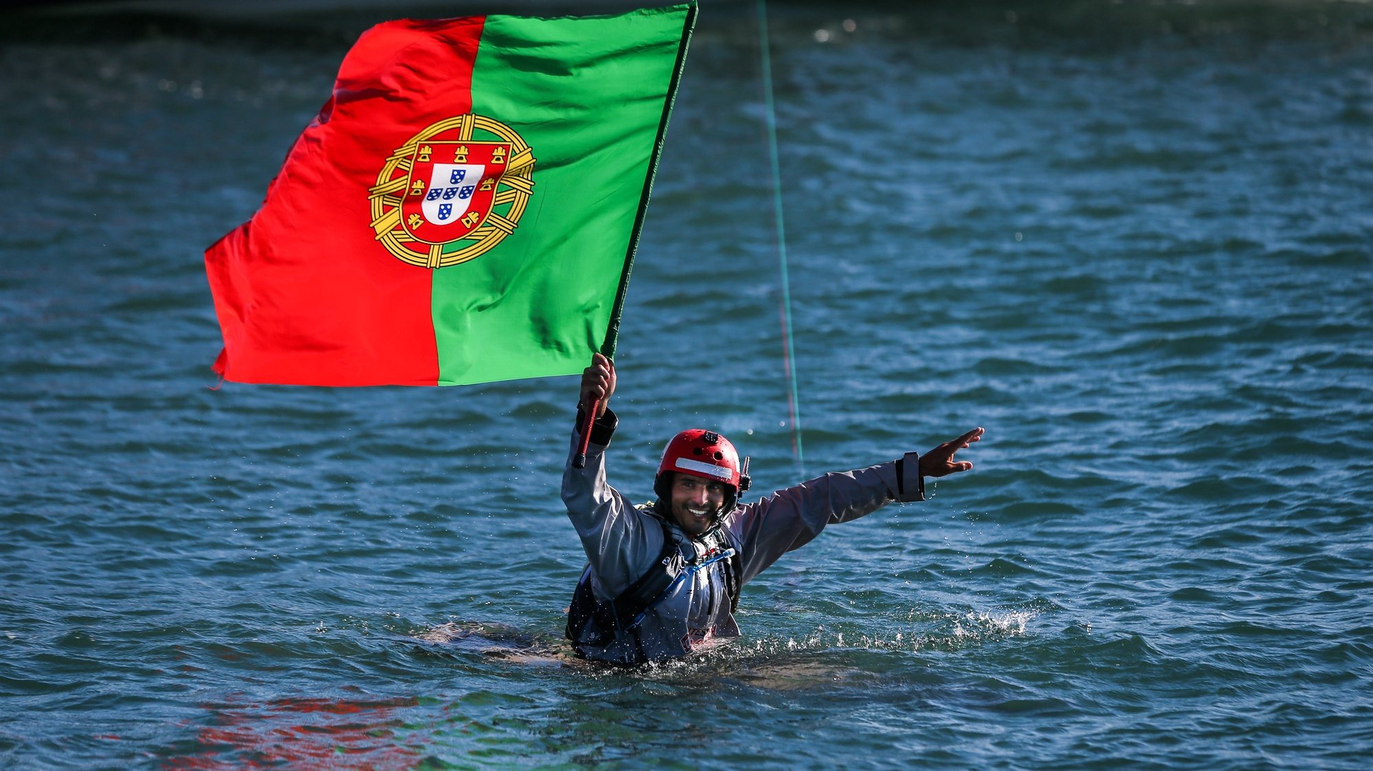 Portuguese kitesurfer, Francisco Lufinha, holds the Portugal flag as he arrives to Oeiras harbour after conquering a new kitesurf world record of the longest kitesurf trip with his partner the German Anke Brandt (not on the picture) between Azores Islands and continental Portugal, Oeiras, Portugal, 13 September 2017. MARIO CRUZ/LUSA