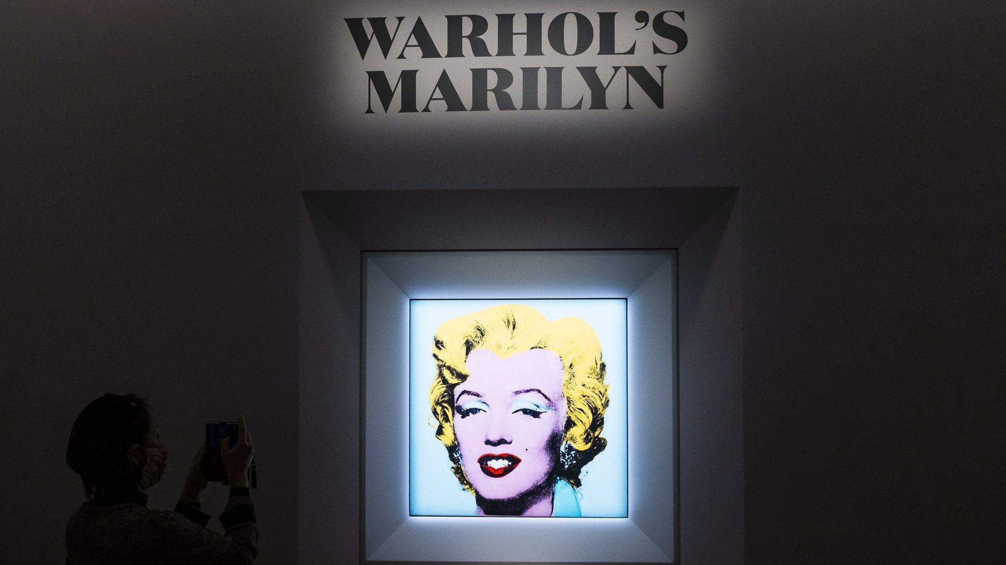 Pessoas olham para a pintura de 1964 &#039;Shot Sage Blue Marilyn&#039; de Andy Warhol durante uma conferência de imprensa que anuncia o próximo leilão de pintura na Christie&#039;s em Nova Iorque, EUA, 21 de março de 2022.