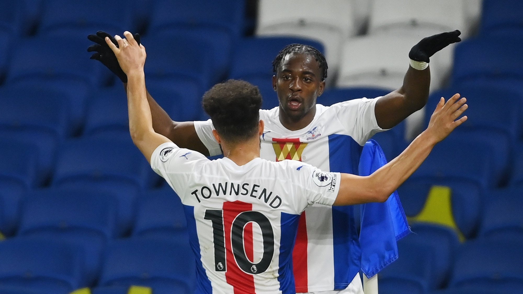 epa09030307 Jean-Philippe Mateta of Crystal Palace celebrates with teammate Andros Townsend after scoring the opening goal during the English Premier League soccer match between Brighton Hove Albion and Crystal Palace in Brighton, Britain, 22 February 2021.  EPA/Mike Hewitt / POOL EDITORIAL USE ONLY. No use with unauthorized audio, video, data, fixture lists, club/league logos or &#039;live&#039; services. Online in-match use limited to 120 images, no video emulation. No use in betting, games or single club/league/player publications.