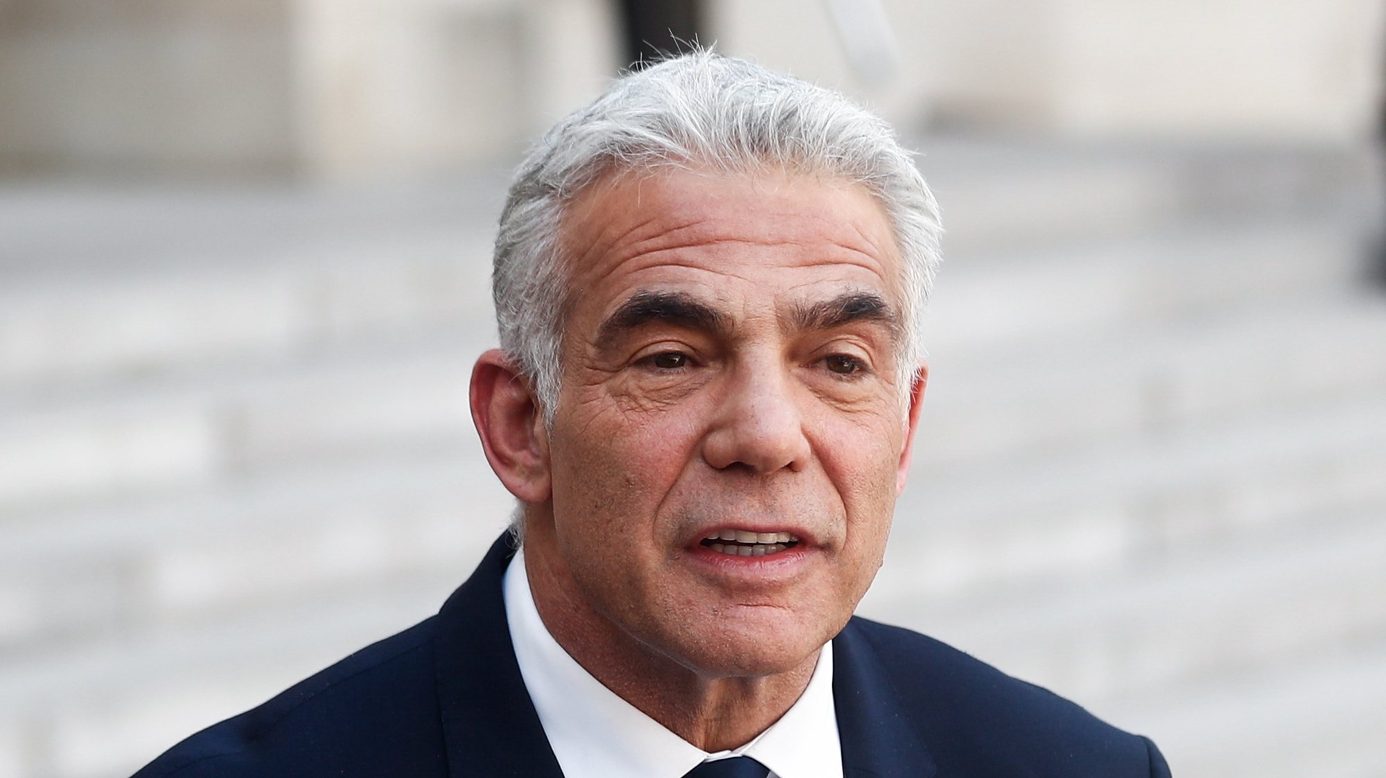 epa10053638 Israeli Prime Minister Yair Lapid speaks at a press conference with French President Emmanuel Macron (not pictured) at the Elysee Palace in Paris, France, 05 July 2022. The new Israeli PM is in France for his first official international visit.  EPA/Mohammed Badra