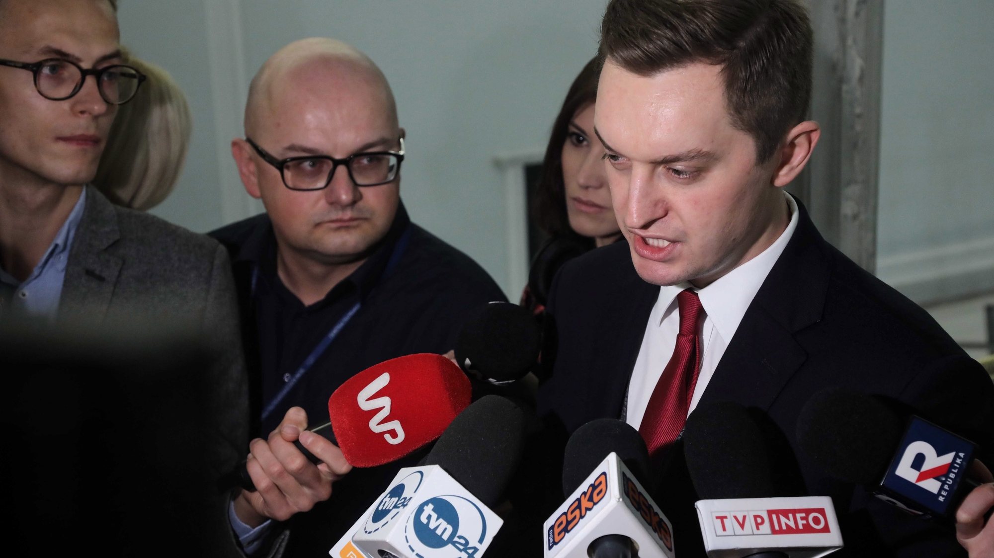 epa08083232 Polish Secretary of State for Justice Sebastian Kaleta (R) talks with journalists before the parliamentary debate on the new judiciary bill in Sejm (lower house) in Warsaw, Poland, 20 December 2019. Last week, MPs from Law and Justice (PiS) submitted a comprehensive draft amendment to provisions relating to the courts and Supreme Court, as well as to administrative and military courts, and prosecutors. According to the authors of the legislation, the new solutions were intended to discipline judges who exceeded their powers. Opponents of the bill warned that the new legislation violates judicial independence.  EPA/WOJCIECH OLKUSNIK POLAND OUT