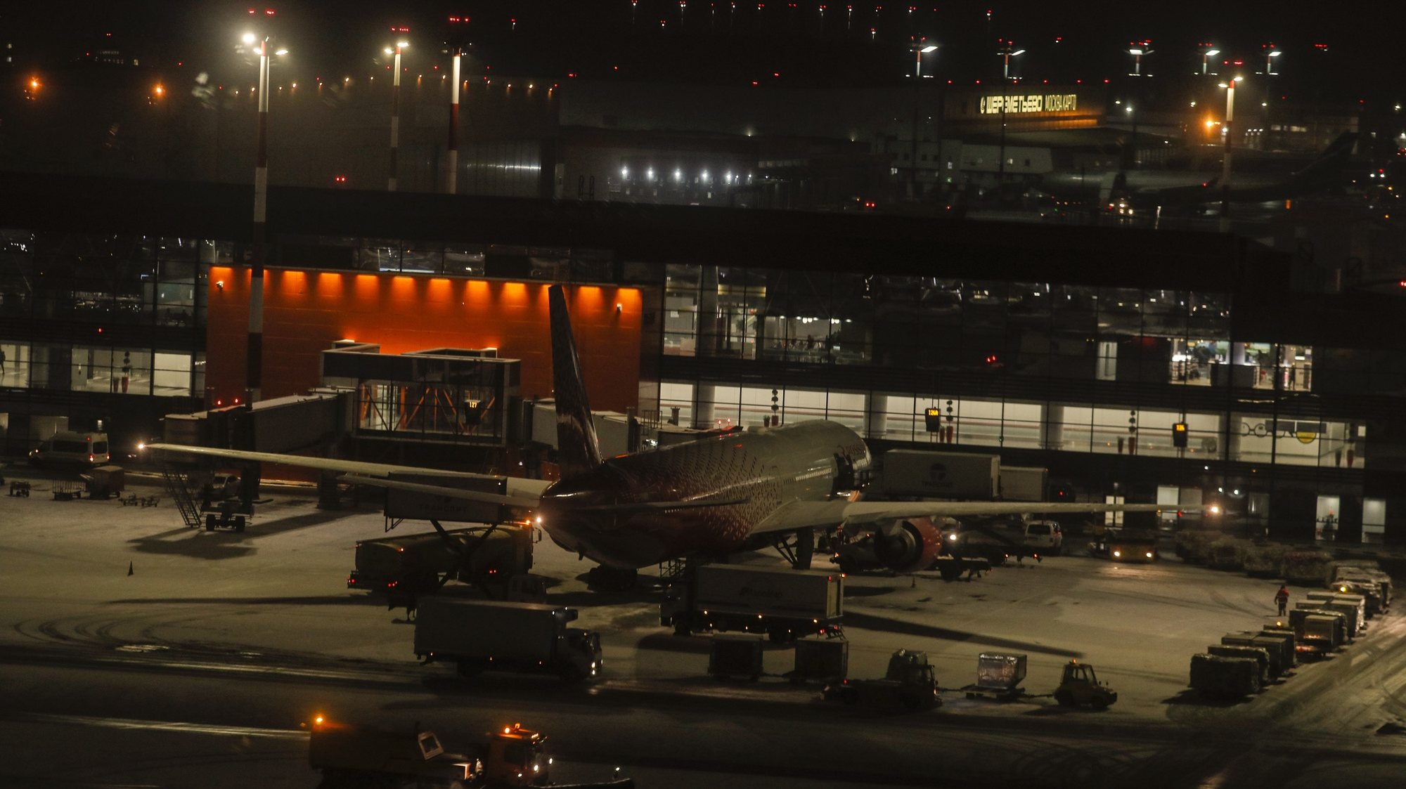 epa08902847 A Rossiya aircraft (Boeing 777-312, Tail number EI-UNM) stands near the Terminal C of the Sheremetyevo International Airport in Moscow, Russia, 24 December 2020. Sheremetyevo Alexander S. Pushkin International Airport is one of four international airports in Moscow.  EPA/SERGEI ILNITSKY