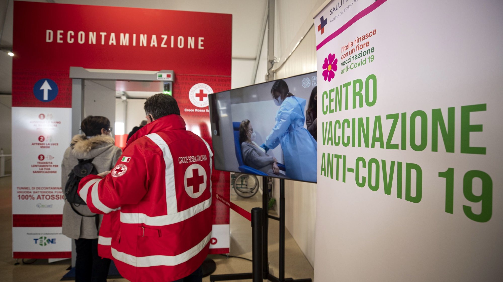 epa09067463 People enter the Italian Red Cross tensile structure set up at Piazza dei Cinquecento to get a coronavirus vaccine against Covid-19 inside, Rome, 11 March 2021.  EPA/MASSIMO PERCOSSI