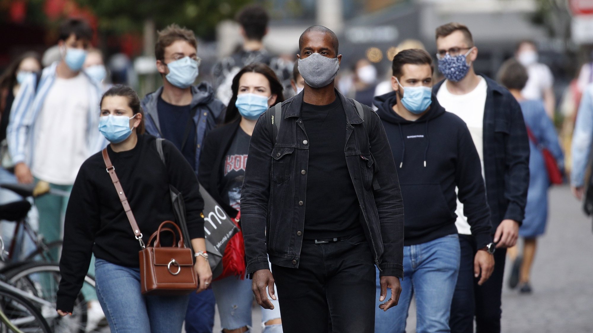 epa08632225 People wearing protective face masks walk in the streets in Paris, France, 28 August 2020. As of 8am on 28 August, protective face masks are mandatory across the city of Paris, a measure annouced by French Prime Minister Jean Castex on 27 August to fight the rising spread of coronavirus SARS-CoV-2 which causes the Covid-19 disease. Cases in France have surged in recent weeks, with over 6000 new cases recorded in a 24 hour period.  EPA/YOAN VALAT