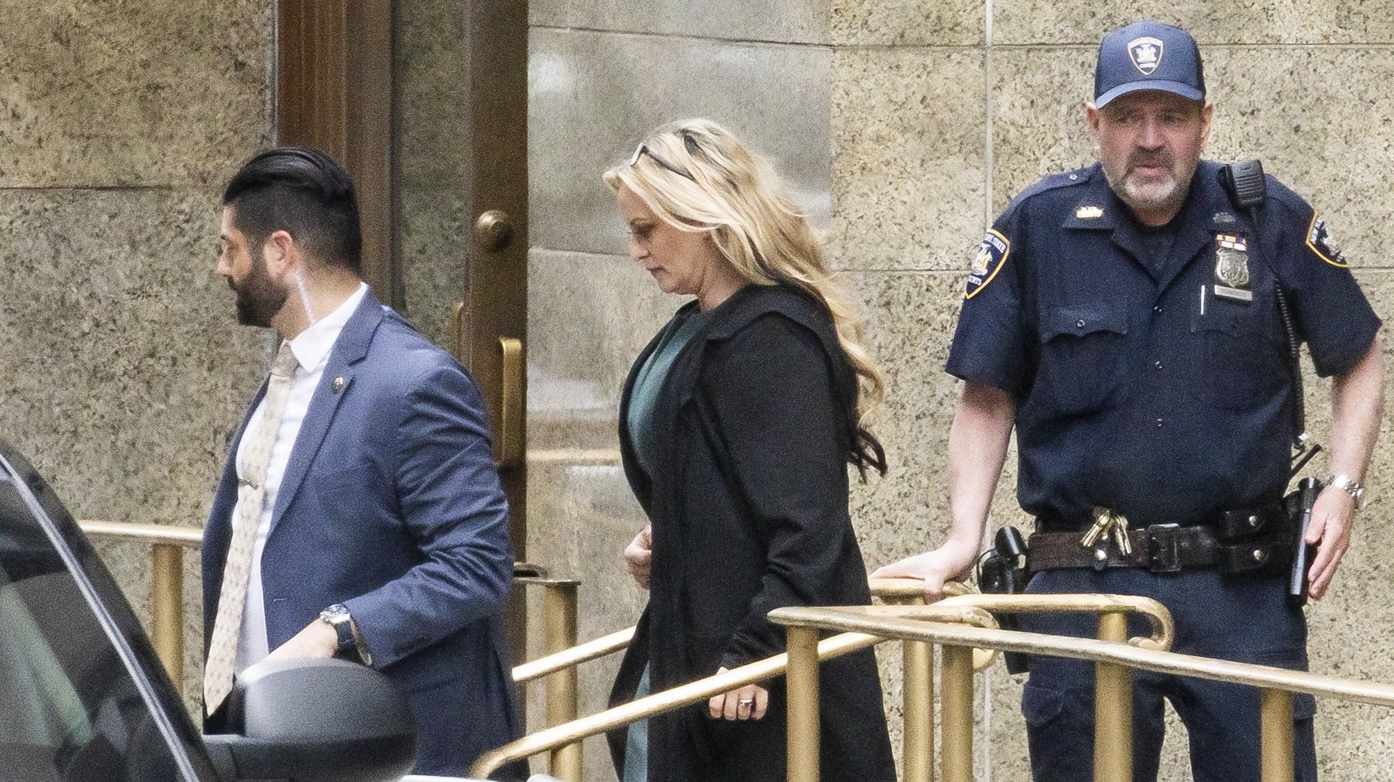 epa11329506 Stormy Daniels (C) departs the Supreme Court of the State of New York after testifying in the hush money trial of former US President Donal Trump, in New York City, USA, 09 May 2024. Trump is facing 34 felony counts of falsifying business records related to payments made to adult film star Stormy Daniels during his 2016 presidential campaign.  EPA/JUSTIN LANE