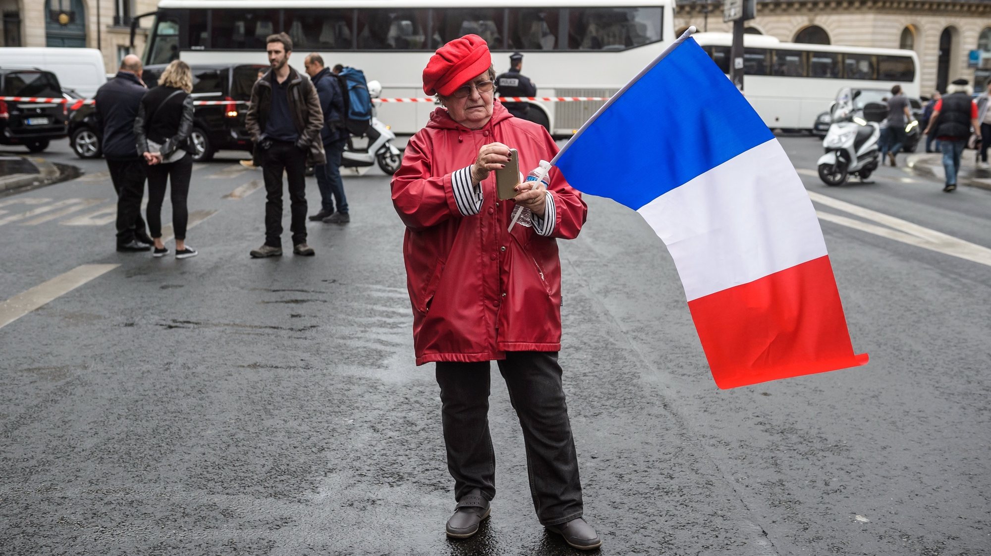 epa06232312 A protester holds a french flag during a demonstration led by french unions for retired against the decrease of the purchasing power in Paris, France, 28 September 2017. This demonstration takes part of a series of national protests against the president Emmanuel Macron new policies.  EPA/CHRISTOPHE PETIT TESSON