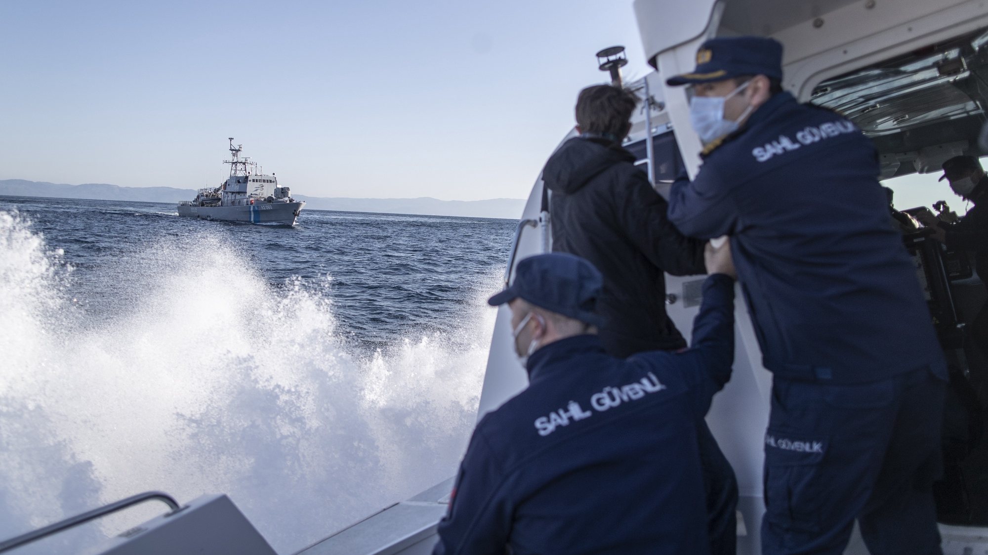 epa09131071 Members of the Turkish Coast Guard give a warning to a Greece Coast Guard ship, which allegedly crossed into Turkish waters, during a patrol to search and rescue for migrants as they pass to or pushed back from Lesvos Island of Greece offshore the Ayvalik district in Balikesir, Turkey, 10 April 2021 (issued 12 April 2012). The Greek island of Lesbos hosts one of the hotspots, an initial reception centers for migrants in European Union. Turkish authorities told epa/Efe that in 2020 around 45 percent of migrants rescued in the Aegean Sea had been pushed back from Greek territory. Most common cases involve migrant vessels being stopped by a Greek patrol when entering Greek waters, but the Turkish coastguard says it has heard lots of migrants describing &#039;delayed pushback,&#039; when people are returned to the sea days after they reached Lesbos. According to Turkish officials, in this case, a Greek patrol carries the detained migrants to the limit of Greek territorial waters before putting them in a life raft and alerting Ankara.  Since the beginning of 2021, Turkey has rescued around 2,700 migrants in the Aegean Sea, and some 1,900 migrants from a pushback.  The Norwegian NGO Aegean Boat Report claims, some 558 people have been abandoned on 35 life rafts at sea so far in 2021. Some such incidents have ended with fatalities, the organizations claimed.  EPA/ERDEM SAHIN  ATTENTION: This Image is part of a PHOTO SET