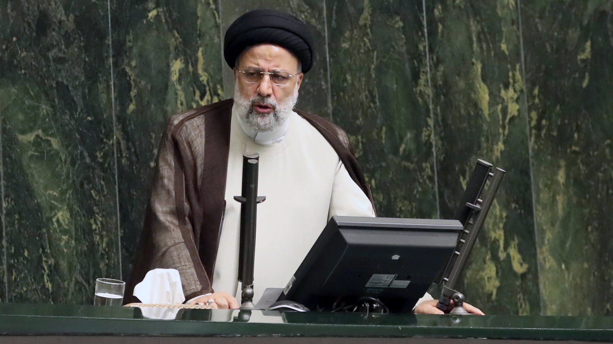 epa10222334 Iranian president Ebrahim Raisi (L) speaks during a parliament session at the Islamic Consultative Assembly in Tehran, Iran, 04 October 2022. On 03 October, the Iranian supreme leader Ayatollah Ali Khamenei gave a speech concerning recent protests, condemning the mobilizations as &#039;riots&#039; and accused the US, Israel, and the west of planning the protests inside the country. Iran has experienced anti-government protest around the country in past three weeks.  EPA/ABEDIN TAHERKENAREH