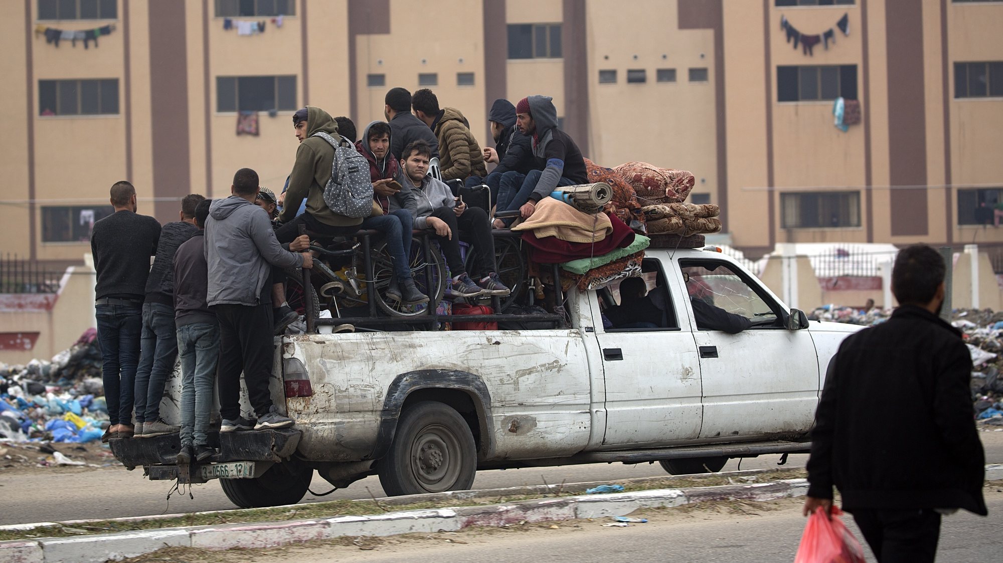 epa11045520 Displaced Palestinians from the Nuseirat, Bureij and parts of the Khan Yunis refugee camps, sit and stand next to their belongings aboard a vehicle as they make their way to the city of Rafah after an Israeli warning of increasing military operations in the Gaza Strip camps, 27 December 2023. Since 07 October, up to 1.9 million people, or more than 85 percent of the population, have been displaced throughout the Gaza Strip, some more than once, according to the United Nations Relief and Works Agency for Palestine Refugees in the Near East (UNRWA), which added that most civilians in Gaza are in &#039;desperate need of humanitarian assistance and protection&#039;.  EPA/HAITHAM IMAD