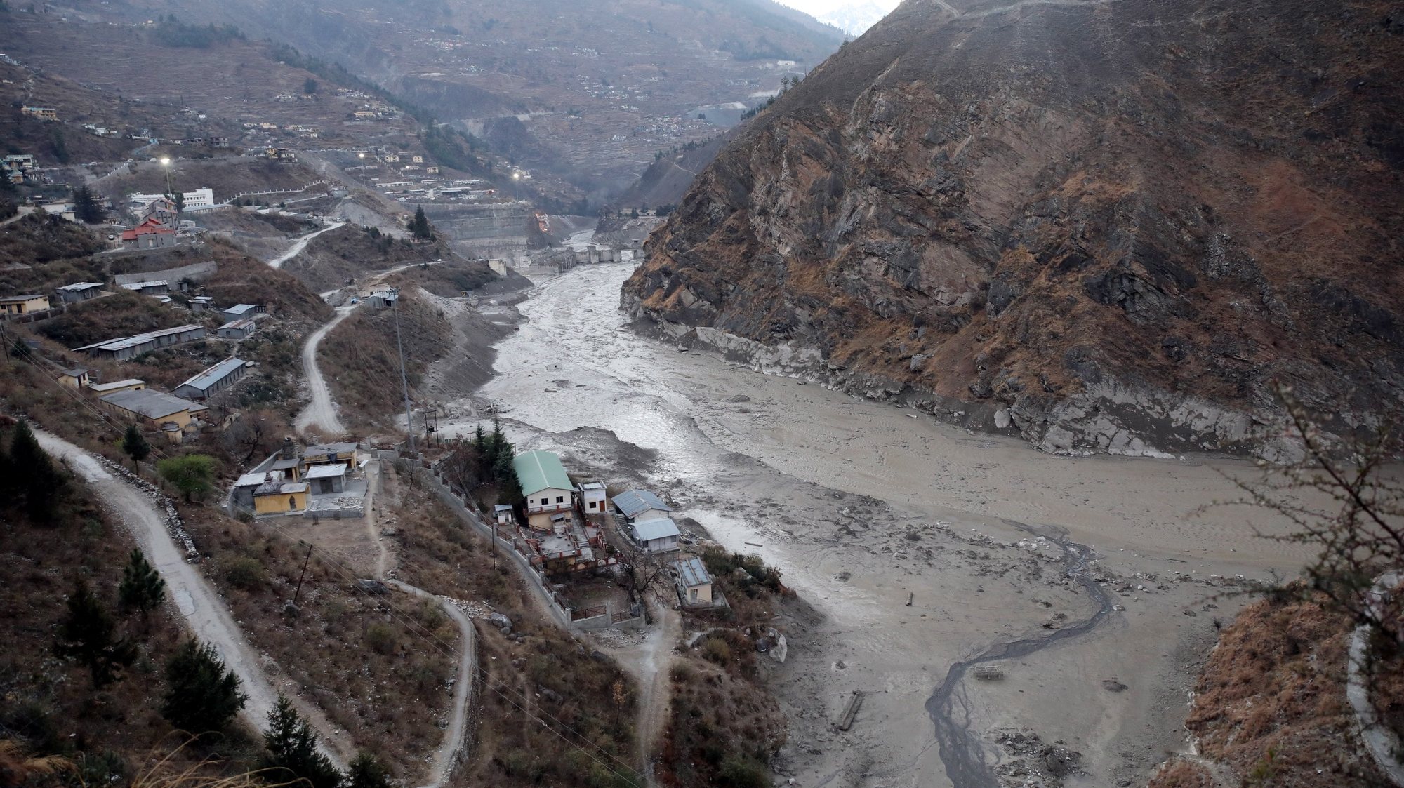 epa08996434 A general view of an area near the Dhauliganga hydro power project after a portion of Nanda Devi glacier broke off, at Reni village in Chamoli district, Uttrakhand, India 08 February 2021. At least 19 people died and nearly 150 are still missing after part of the Nanda Devi glacier fell into the river, triggering a flood that burst open a dam in the Tapovan area of Uttarakhand&#039;s Chamoli district on 07 February 2021.  EPA/RAJAT GUPTA
