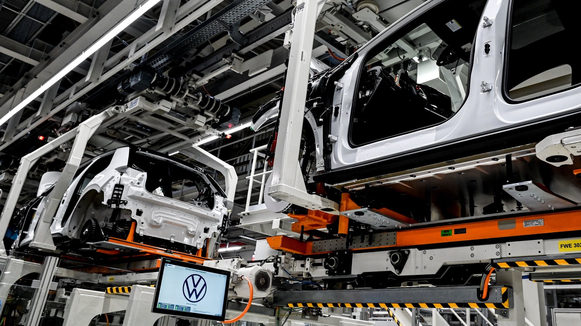 epa09910739 Electric cars assembly line at the Volkswagen (VW) vehicle factory in Zwickau, Germany 26 April 2022. In 2021 Volkswagen doubled its electric cars sales compared with 2020 as company is continuing to the transition to e-mobility.  EPA/FILIP SINGER