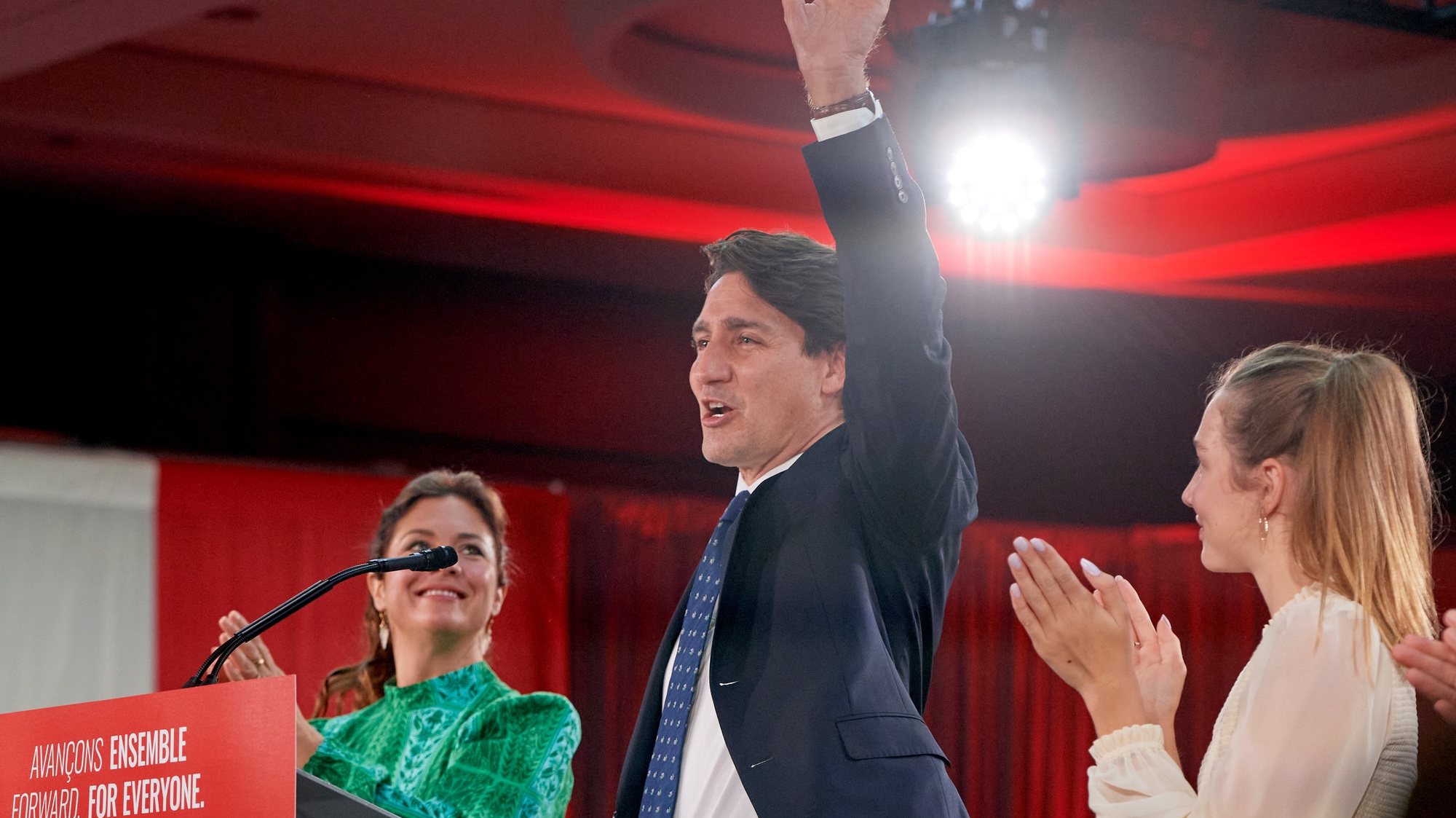 epa09478683 Canadian Prime Minister and Liberal Party leader Justin Trudeau (C), next to his wife Sophie Gregoire (L) and daughter Ella Grace (R), waves to supporters as he celebrates his election victory in Montreal, Quebec, Canada, 20 September 2021. Liberal Party leader Justin Trudeau retained his position as Canadian prime minister in the federal election but will be forced to form a minority government.  EPA/ERIC BOLTE