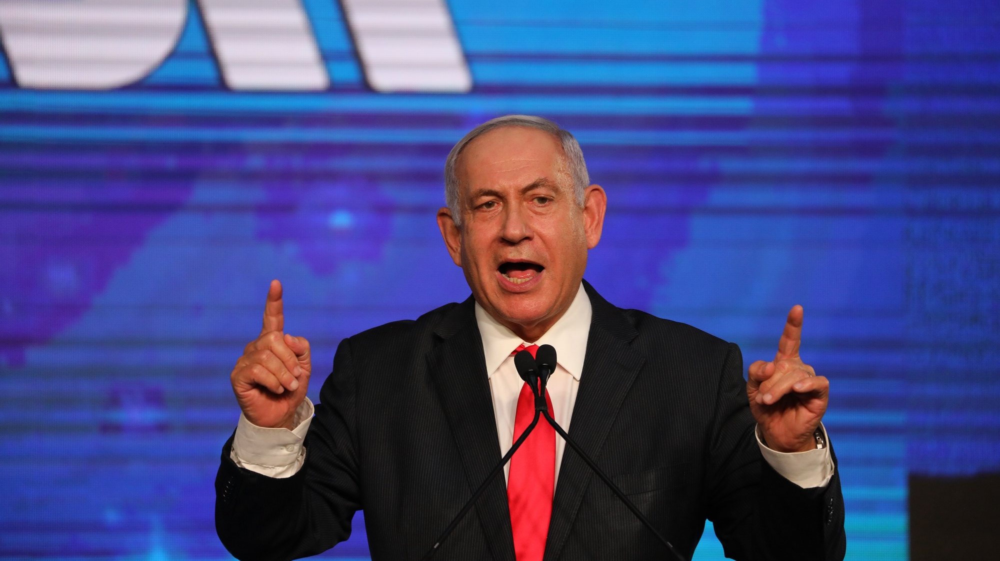 epa09092560 Israeli Prime Minister and Chairman of the Likud Party, Benjamin Netanyahu, greets supporters at the Likud party final election event after early exit polls in Jerusalem, Israel, early 24 March 2021.  EPA/ABIR SULTAN