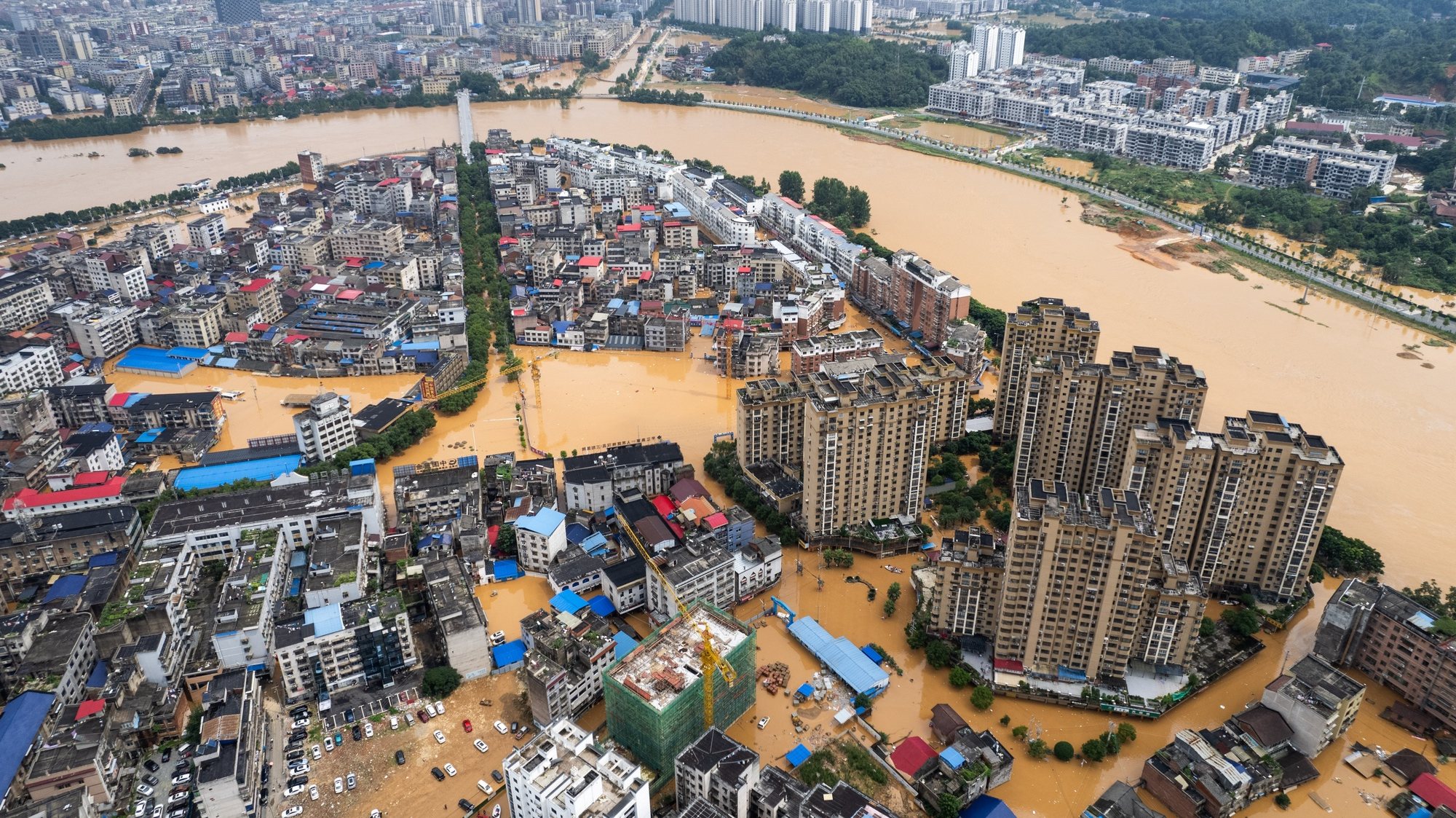 epa11452960 An aerial drone photo shows the waterlogged downtown of Pingjiang county, central China&#039;s Hunan Province, July 2, 2024. The flooding water in Pingjiang county is gradually declining Tuesday with the water level of Pingjiang watch station of the Miluo River at 76.18 meters, still 5.68 meters above the warning mark, but 1.49 meters lower than the peak level.  EPA/XINHUA / Chen Sihan CHINA OUT / UK AND IRELAND OUT  /       MANDATORY CREDIT EDITORIAL USE ONLY