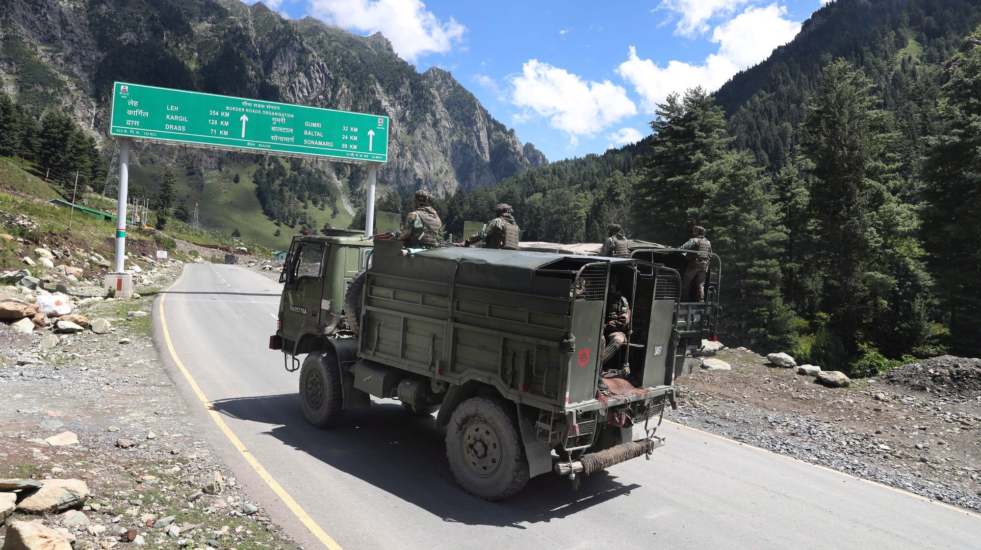 epa08658802 Indian army vehicles move along a highway leading to Ladakh, at Gagangeer some 81 kilometers from Srinagar, the summer capital of Indian Kashmir, 07 September 2020 (issued 10 September 2020). Apart from nomadic families with goats, sheep and horses, no one is allowed to travel along the normally bustling mountain road to allow the Indian military to operate freely amid a months-long standoff between India and China along the disputed border in eastern Ladakh.  EPA/FAROOQ KHAN