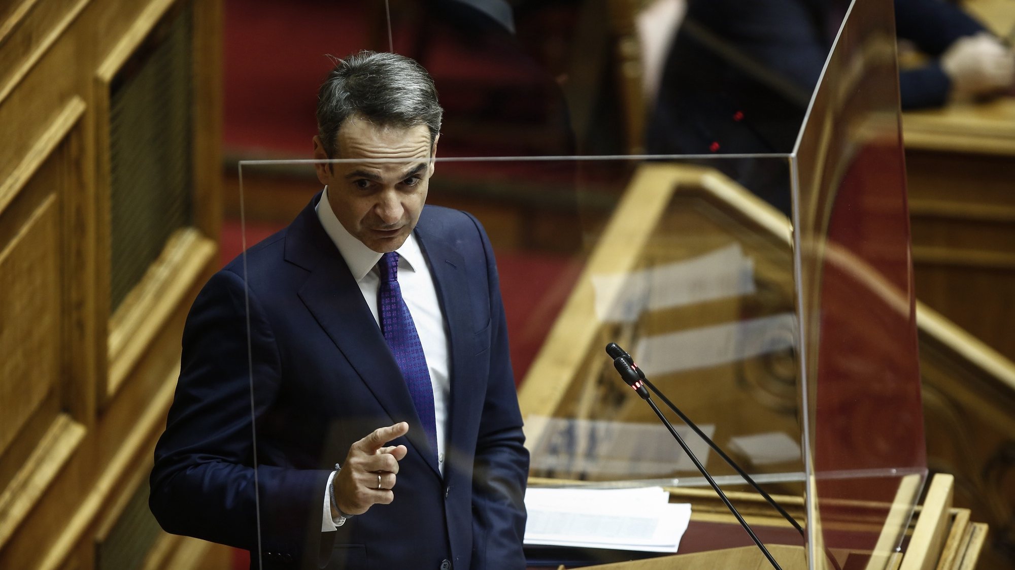 epa08885788 Greek Prime Minister Kyriakos Mitsotakis delivers his speech during a parliament session of a vote on 2021 budget in Athens, Greece, 15 December 2020. Greek lawmakers will be voting on the country&#039;s 2021 budget after midnight concluding a five-day debate in parliament. The debate will end with an address by Prime Minister Kyriakos Mitsotakis, which will follow the speeches of the opposition party leaders.  EPA/YANNIS KOLESIDIS